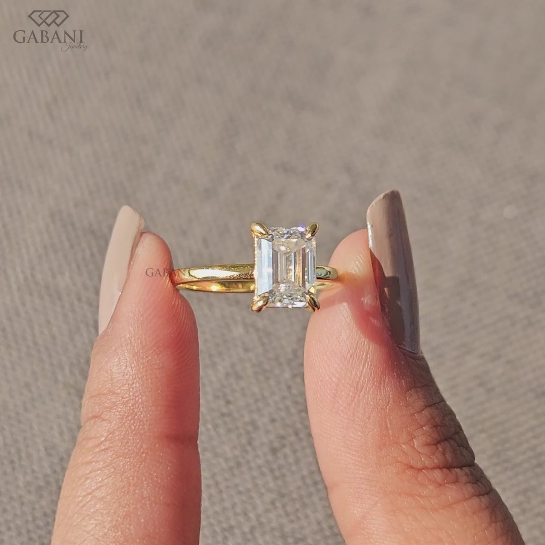 Four prong emerald cut lab grown diamond ring in yellow gold
