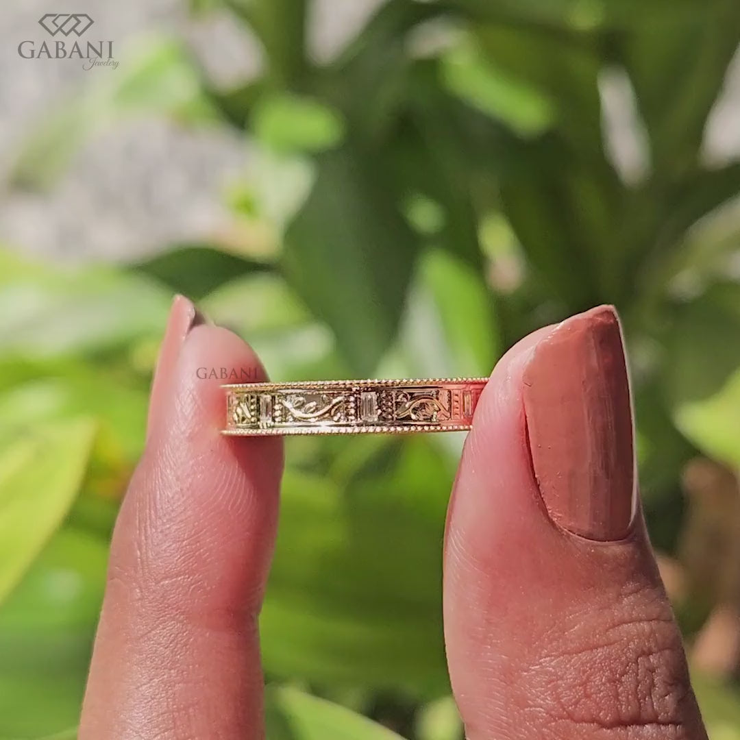 Baguette cut lab grown diamond wedding band with vintage floral engraving, milgrain edges, and polished yellow gold finish.