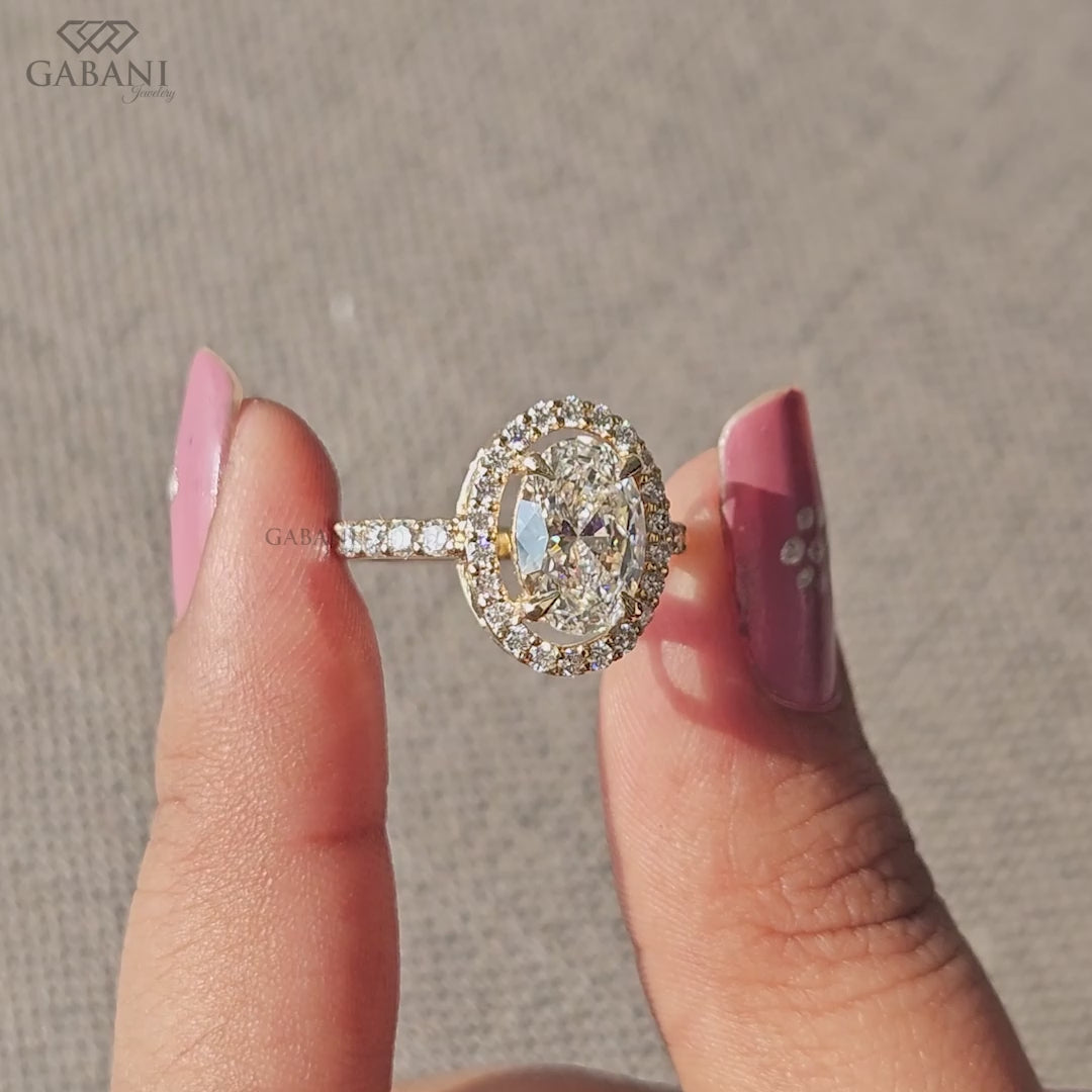 Oval lab grown diamond halo ring set in solid yellow gold