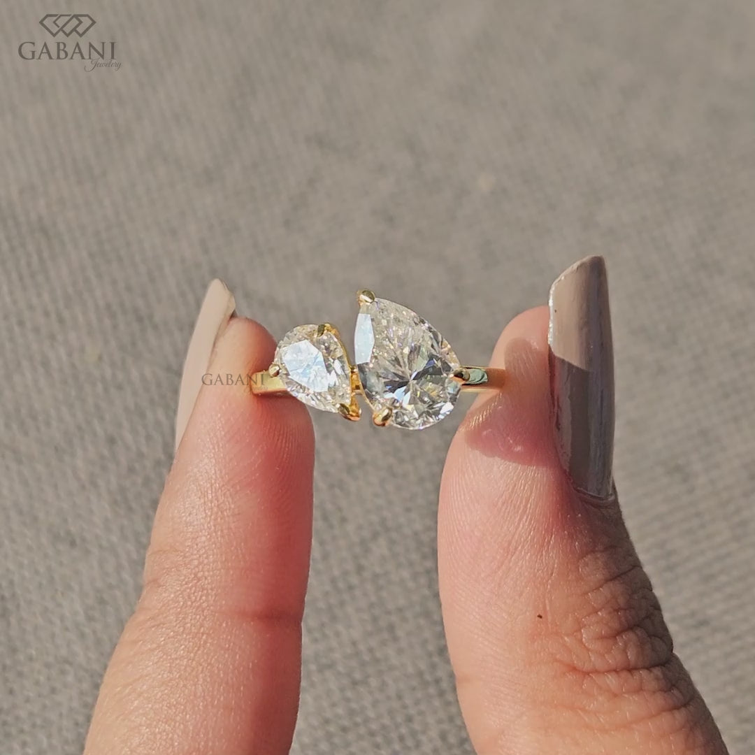 you and me ring featuring pear cut lab grown diamonds in yellow gold with a balanced two stone design