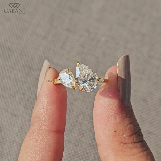 you and me ring featuring pear cut lab grown diamonds in yellow gold with a balanced two stone design