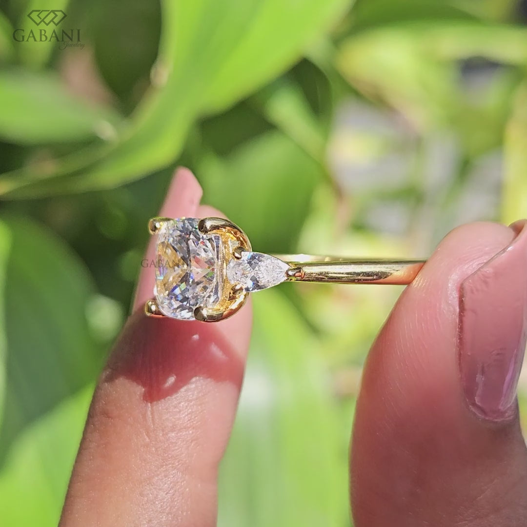 Three stone cushion cut lab grown diamond ring with pear side stones