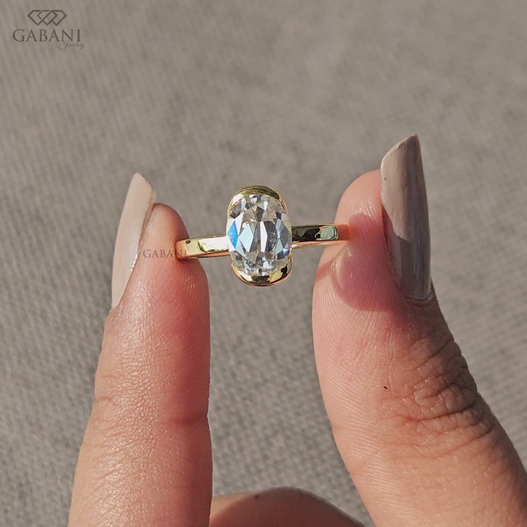 Oval lab grown diamond solitaire ring with half bezel setting
