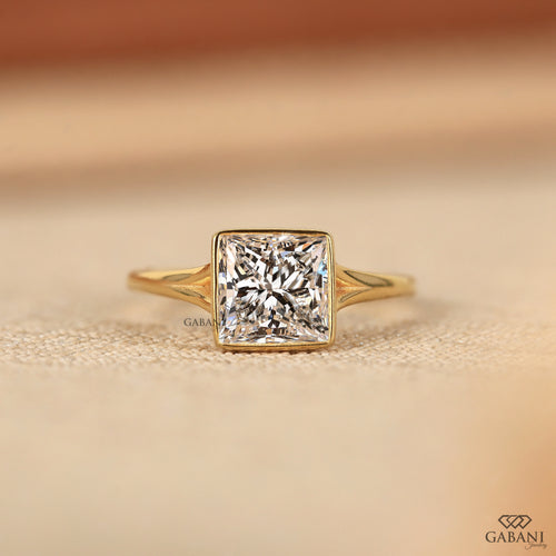 princess cut lab grown diamond engagement ring in 18K yellow gold with a full bezel setting and tapered polished band.