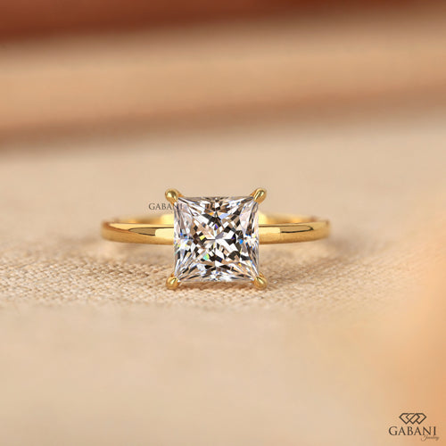 Side view of princess cut lab grown diamond solitaire engagement ring in 18K yellow gold with a classic four prong setting and polished band.