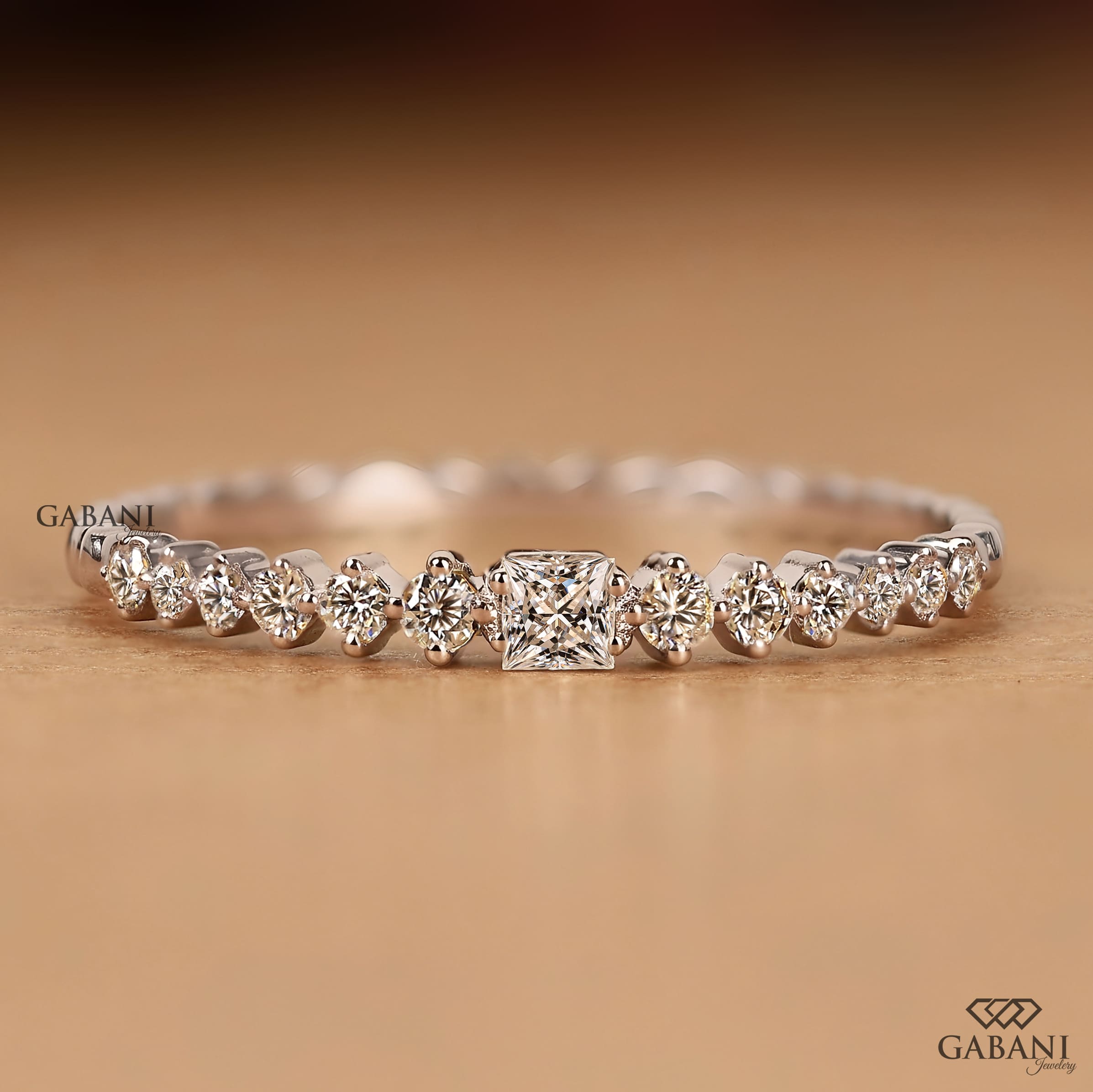 Princess cut and round lab grown diamond wedding band in white gold with graduated prong set diamond design.