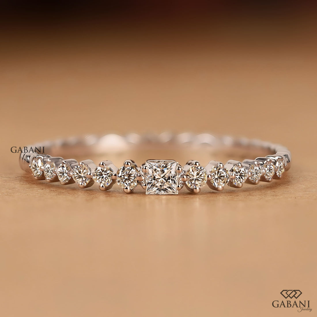 Princess cut and round lab grown diamond wedding band in white gold with graduated prong set diamond design.