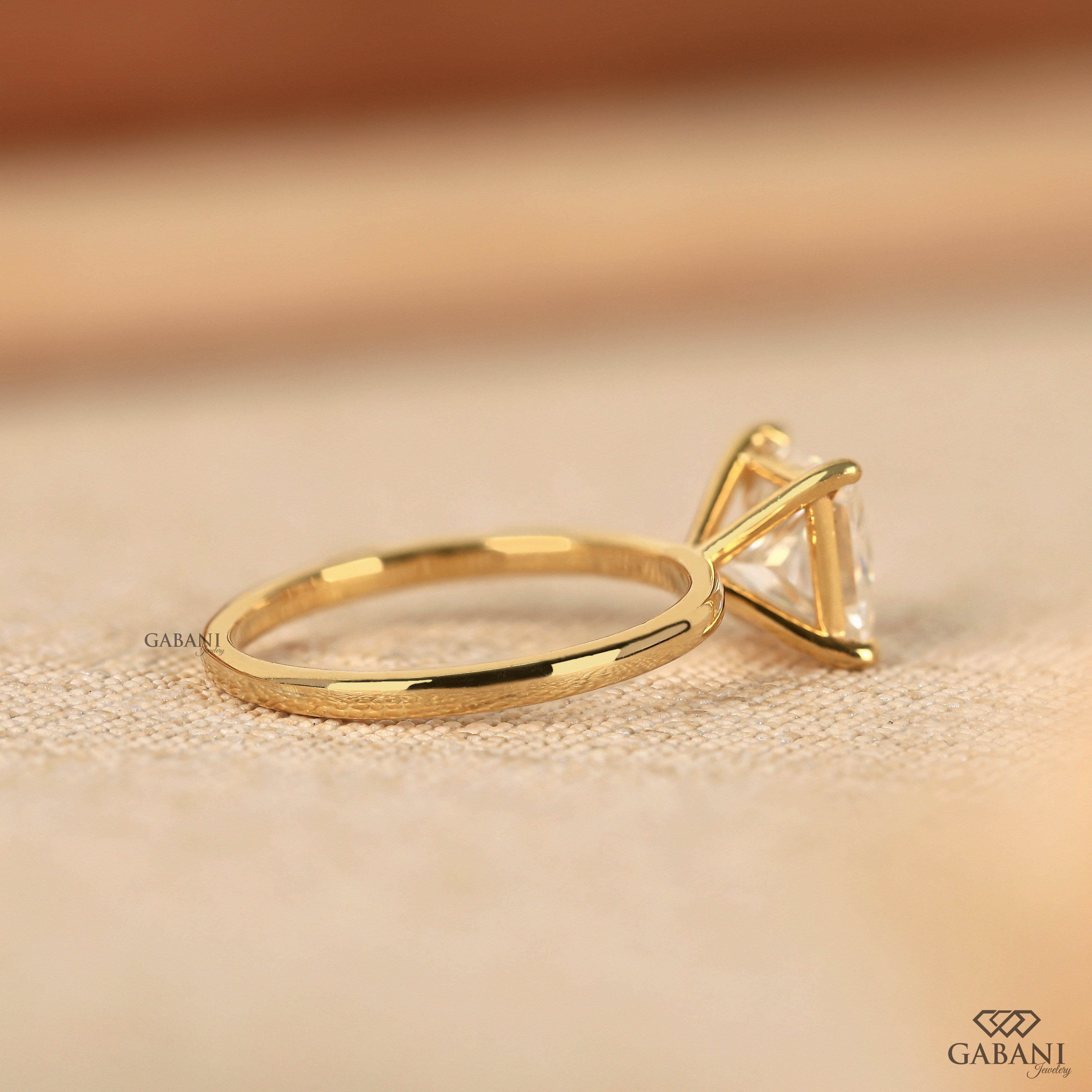 princess cut lab grown diamond solitaire engagement ring in 18K yellow gold with a classic four prong setting and polished band.