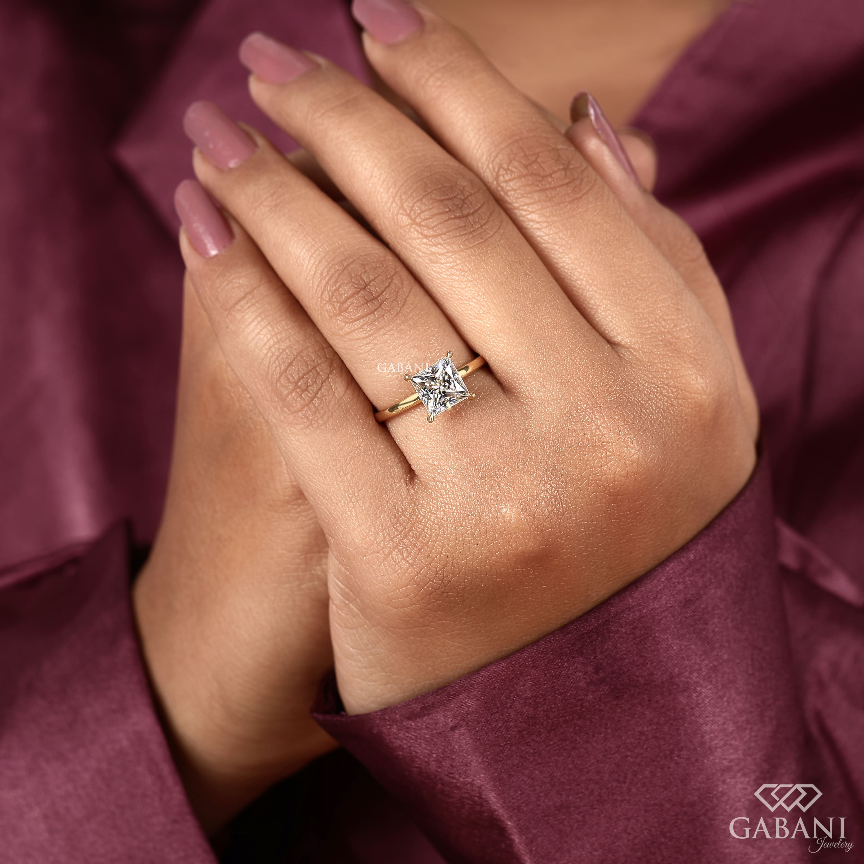 princess cut lab grown diamond solitaire engagement ring in 18K yellow gold with a classic four prong setting and polished band.