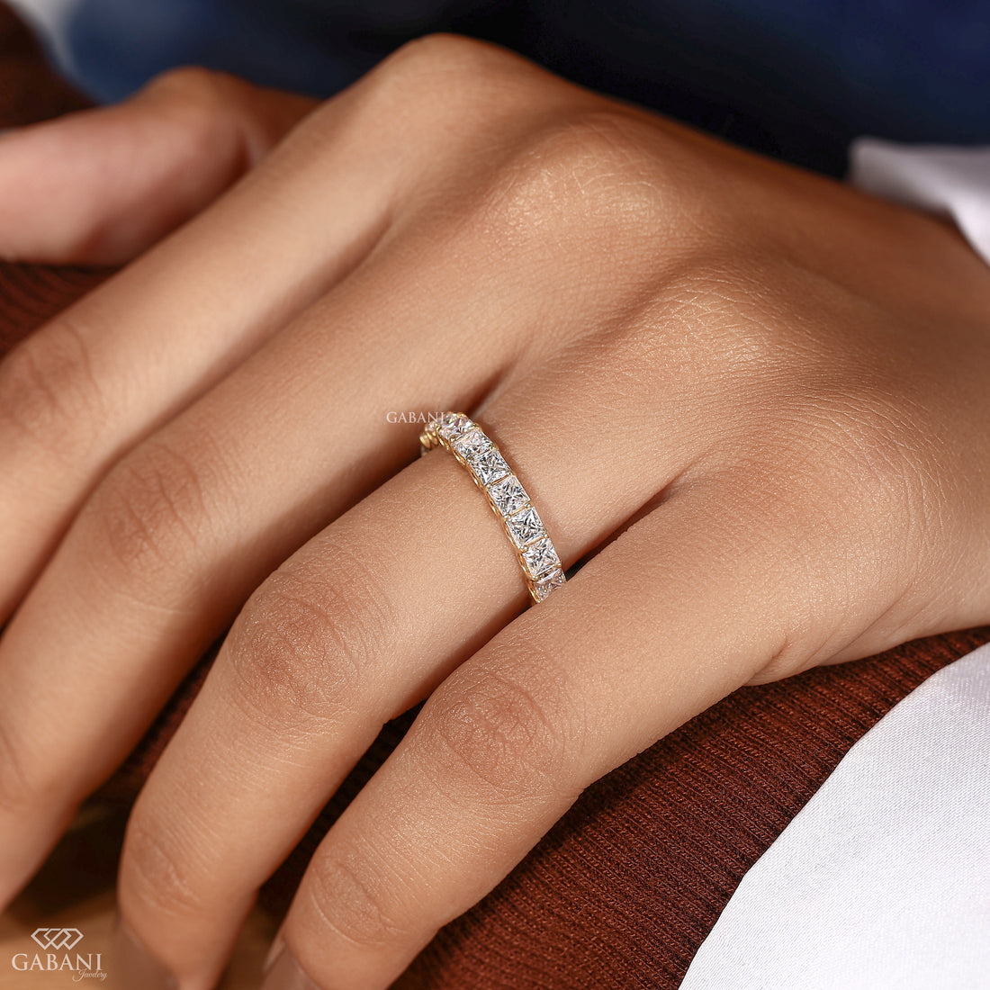 Close-up detail of a princess cut lab grown diamond wedding band with a full eternity design and handcrafted U prong setting.