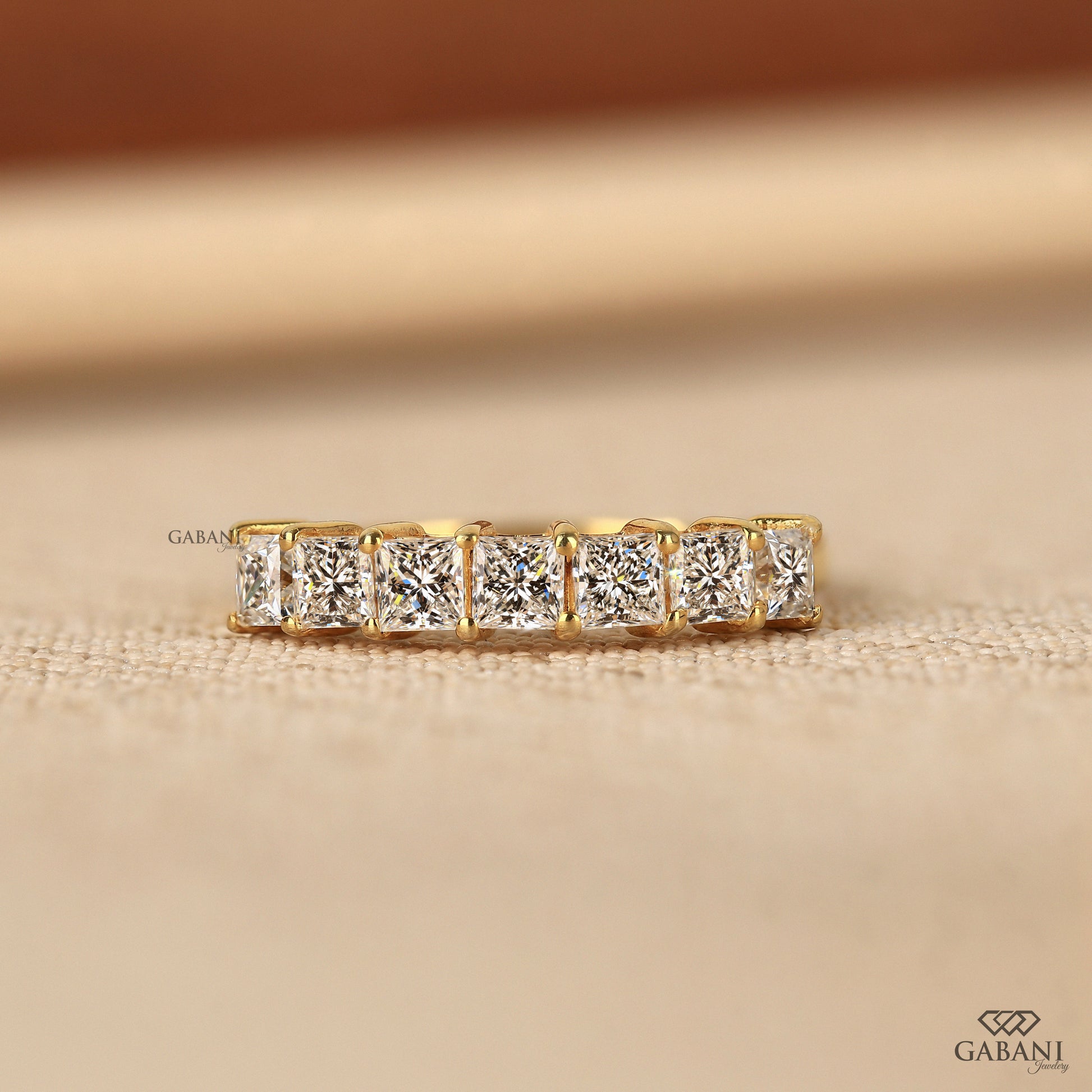 7 stone princess cut lab grown diamond half eternity band in yellow gold
