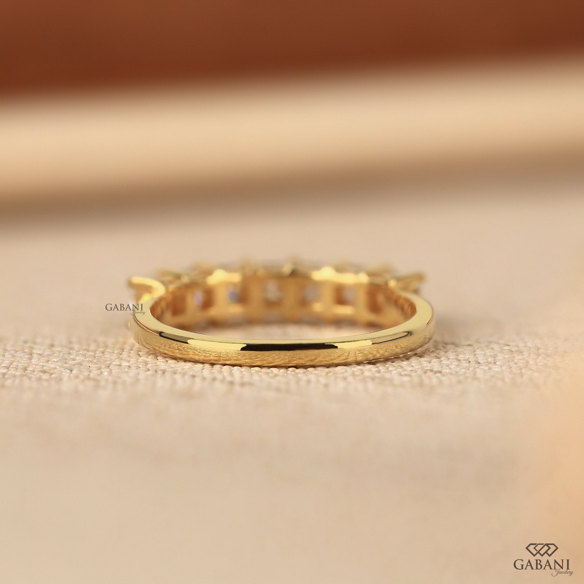 Yellow gold band with seven stone princess cut lab grown diamonds
