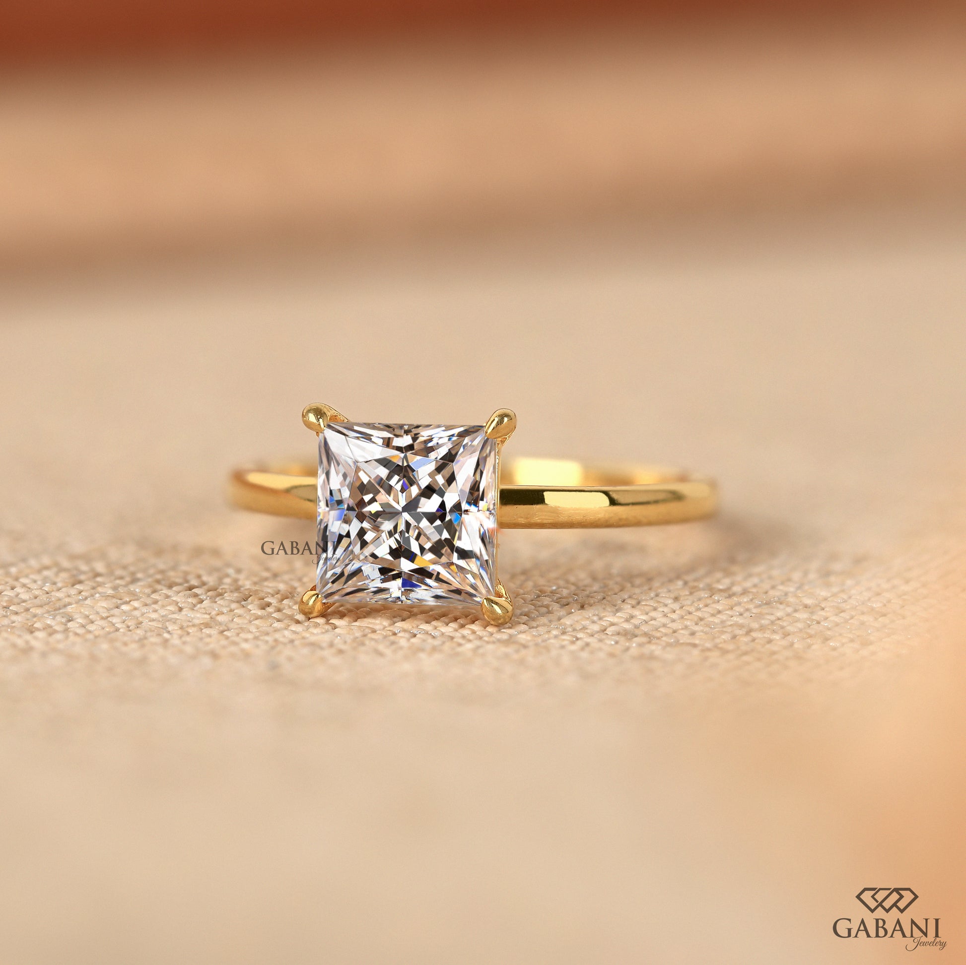 Princess cut lab grown diamond ring featuring pipe shank and solitaire layout