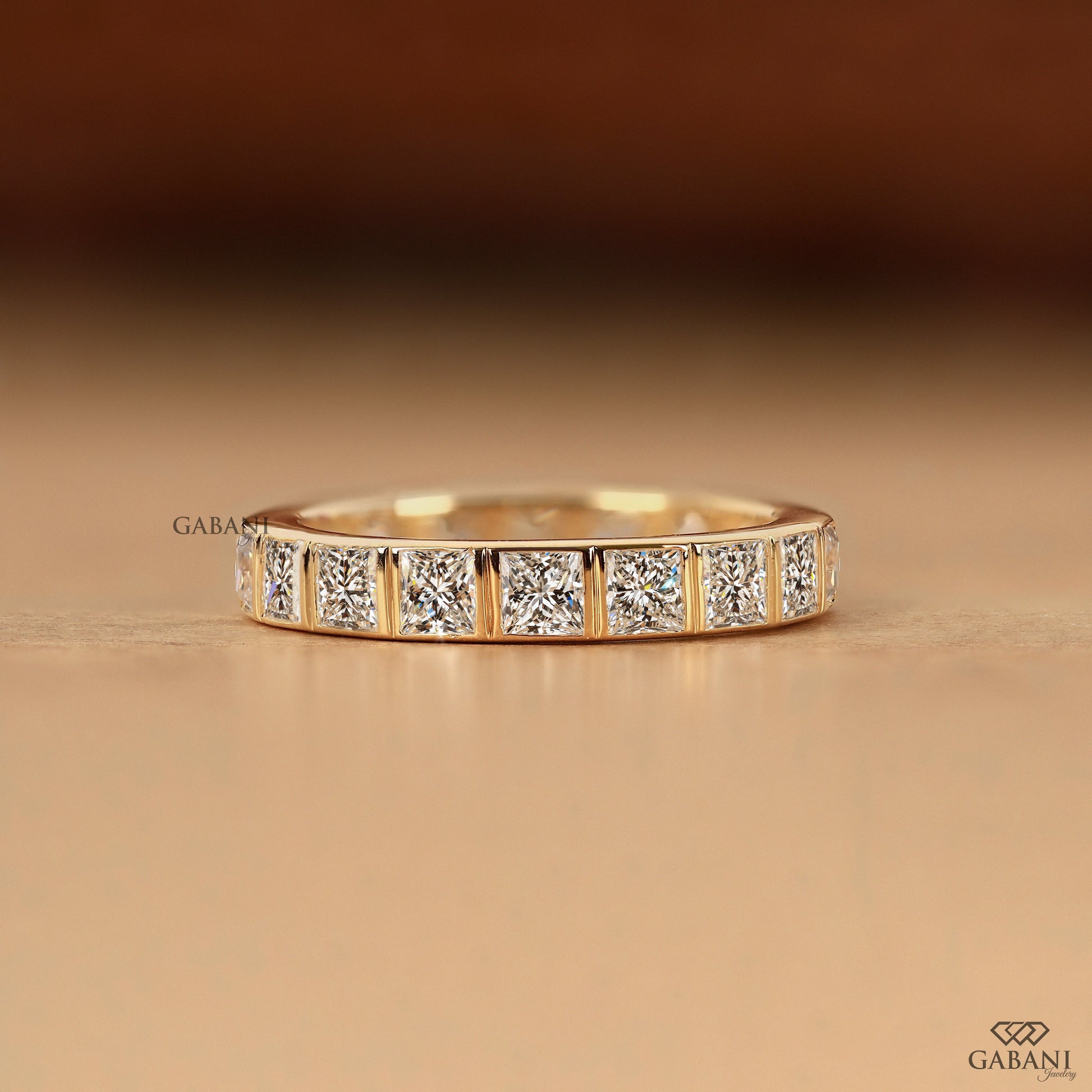 princess cut lab grown diamond bezel wedding band with thick gold band by Gabani Jewelry