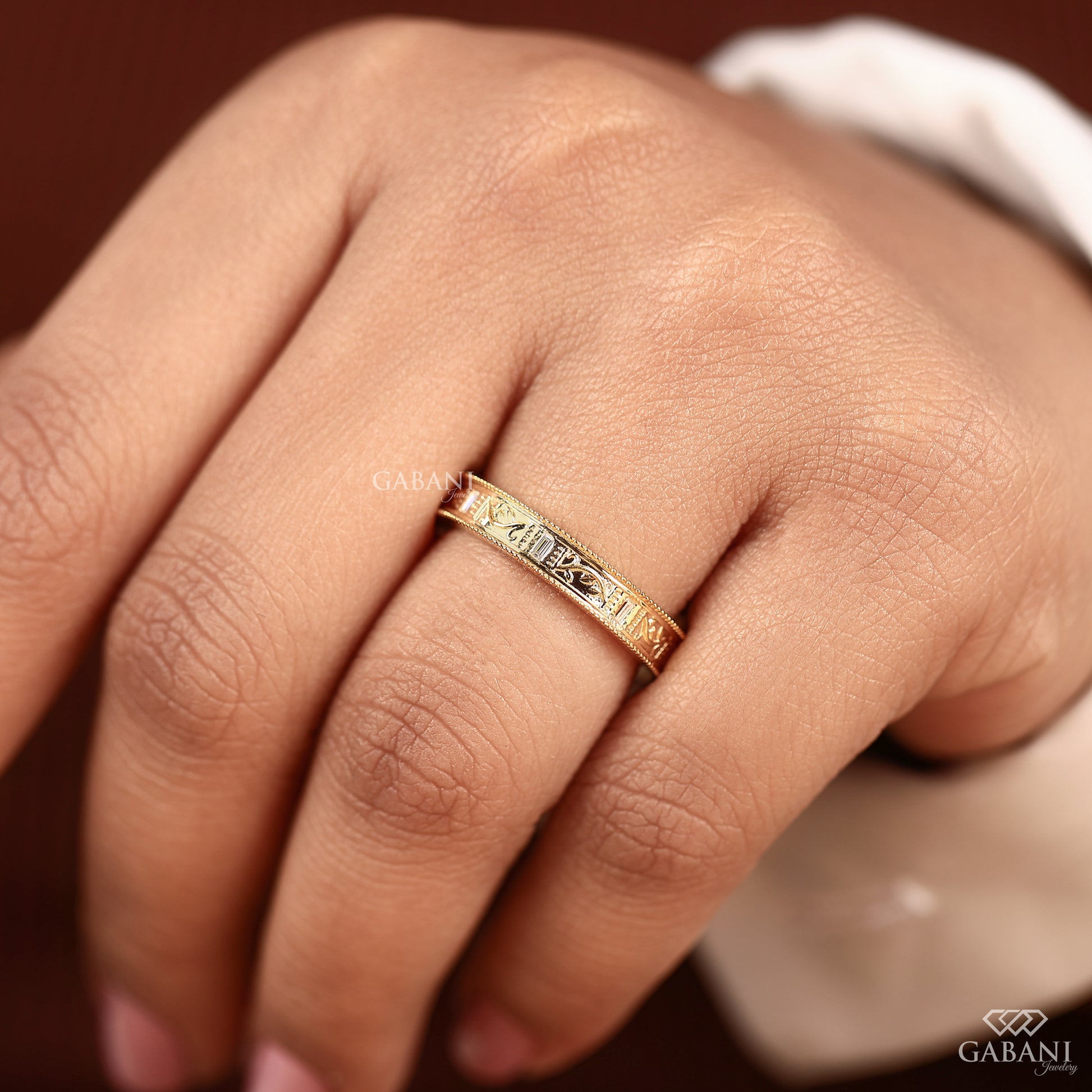 Matching milgrain bands in yellow gold styled together, showcasing coordinated leaf design for bridal set or stacking wear