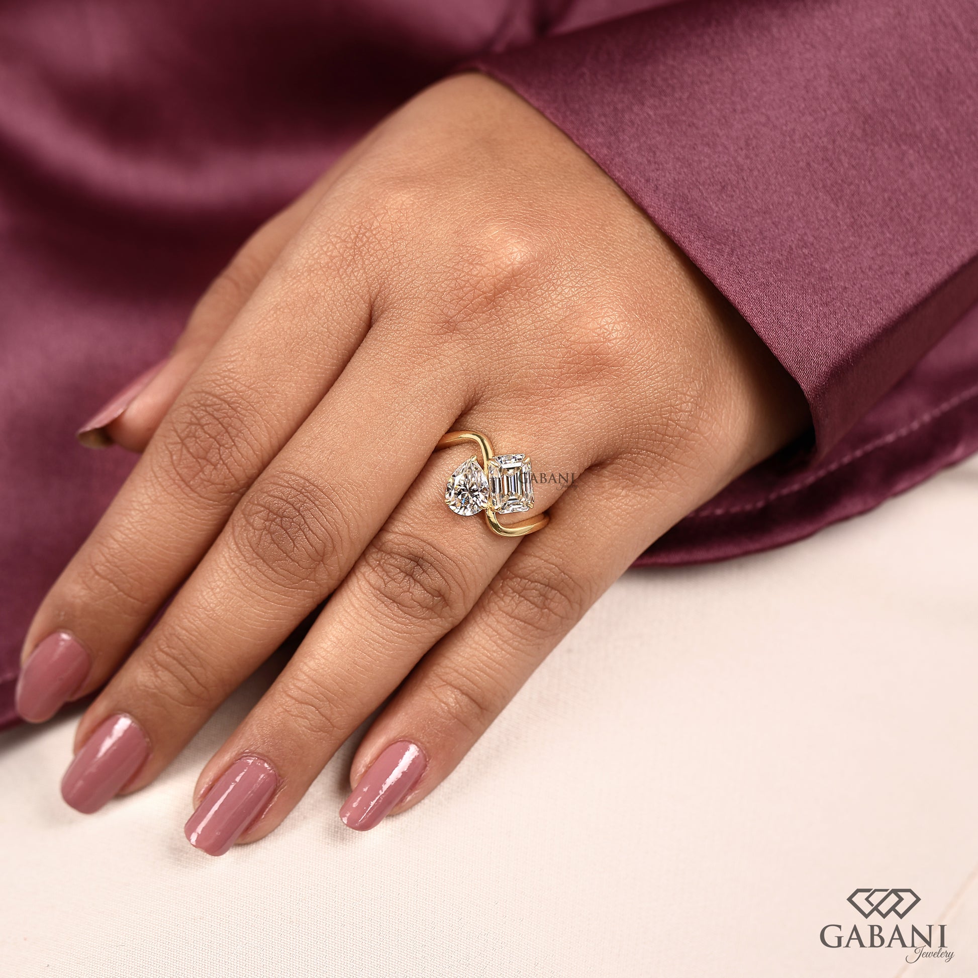 you and me ring with contrasting emerald and pear lab grown diamonds in a modern yellow gold style