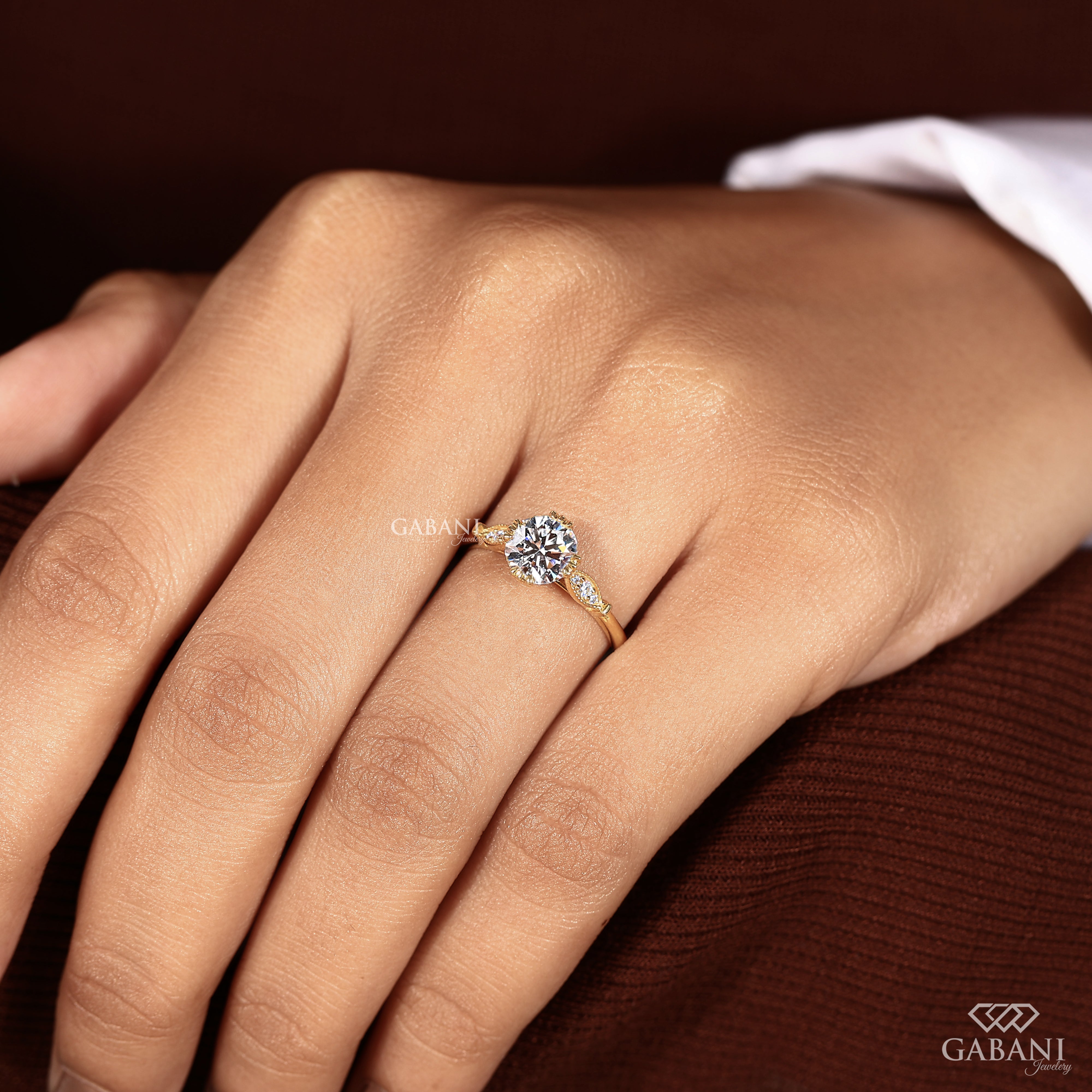 Round brilliant lab created diamond engagement ring worn on model hand