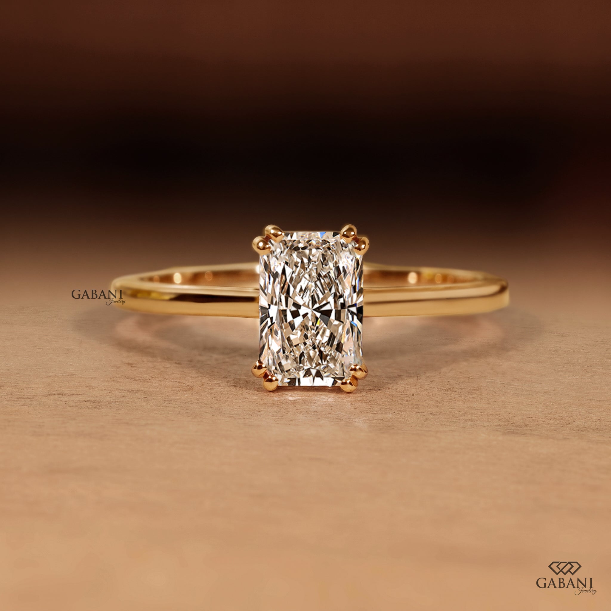 Radiant cut lab grown diamond engagement ring in 18K yellow gold with double claw prongs, elongated center stone and a slim polished solitaire band.