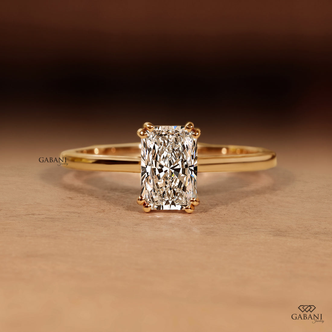 Radiant cut lab grown diamond engagement ring in 18K yellow gold with double claw prongs, elongated center stone and a slim polished solitaire band.