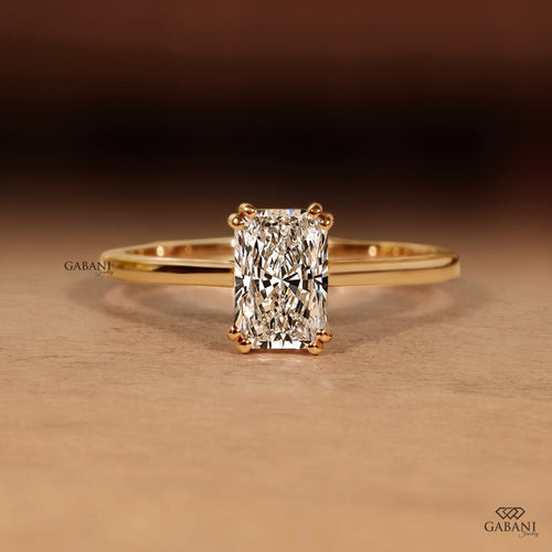Radiant cut lab grown diamond engagement ring in 18K yellow gold with double claw prongs, elongated center stone and a slim polished solitaire band.