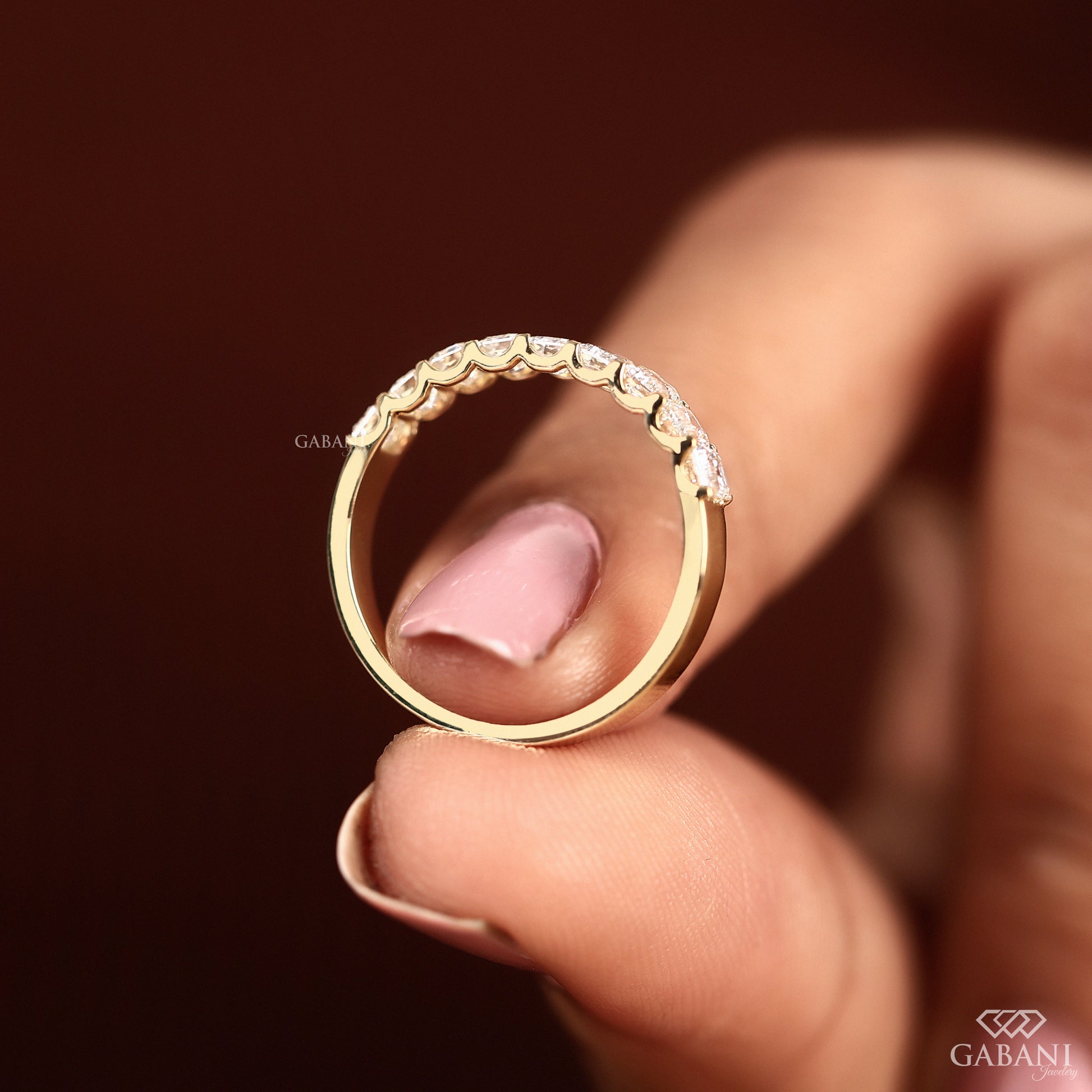 emerald cut diamond stacking band in yellow gold with 9 stone half eternity layout
