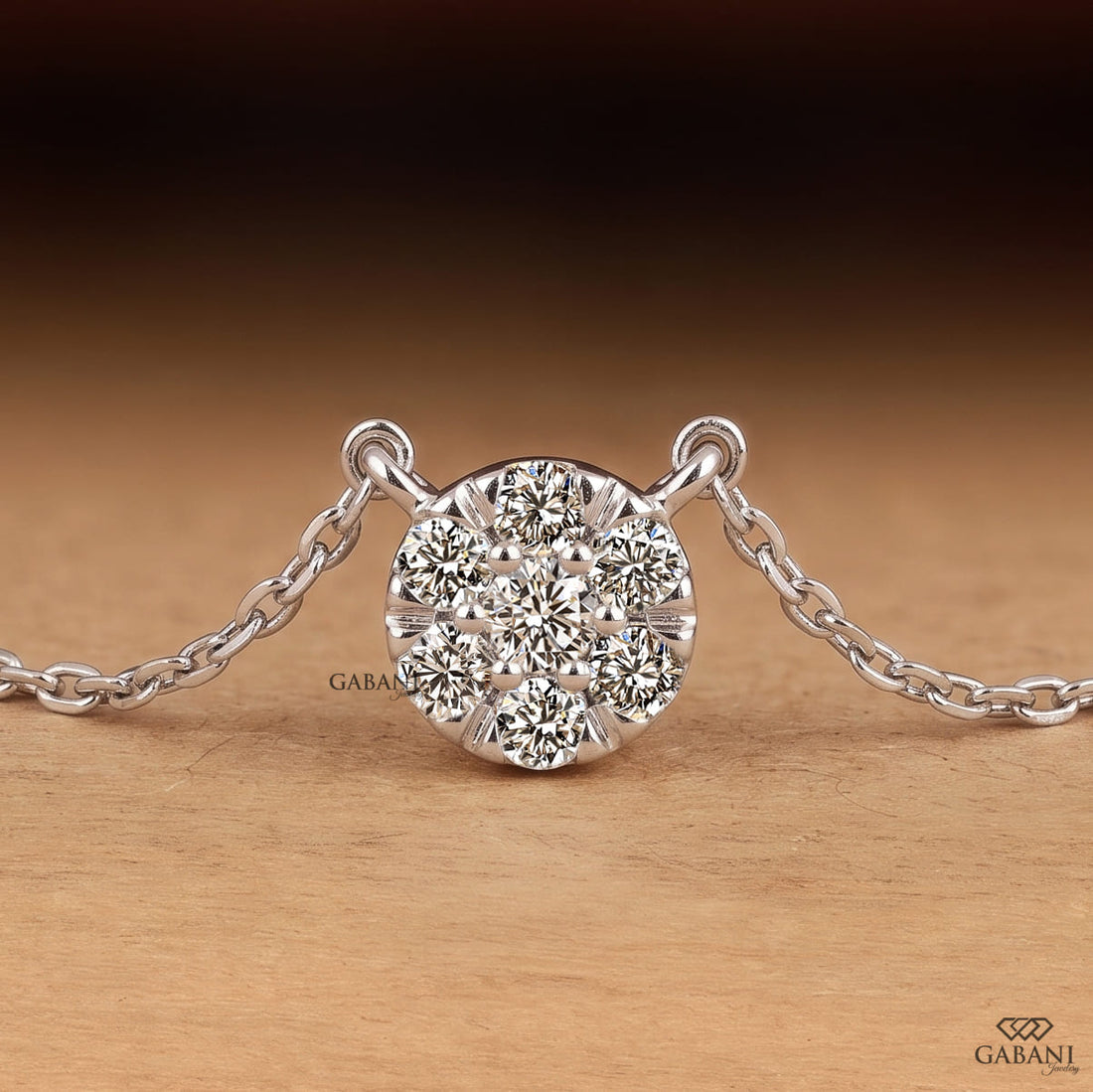 Seven stone round cut lab grown diamond floral cluster necklace in 18K white gold with a delicate cable chain and prong setting.