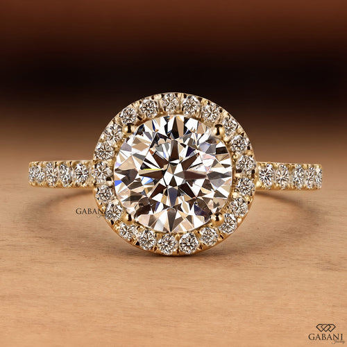 round brilliant cut lab grown diamond engagement ring with a sparkling diamond halo and yellow gold pavé band.