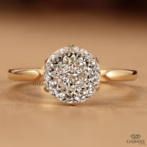Round Portuguese cut lab grown diamond solitaire engagement ring in yellow gold with a six-prong tulip basket and polished plain band.