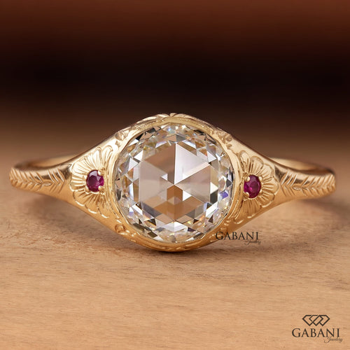 Round rose cut lab grown diamond engagement ring with ruby side accents, floral engraving, and bezel setting