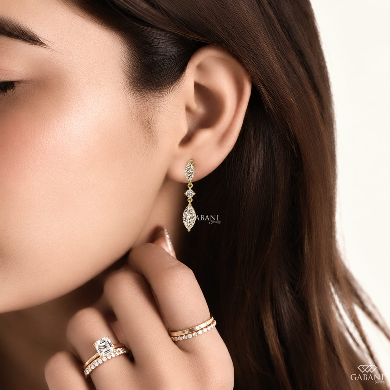 marquise and round cut lab grown diamond drop earrings in yellow gold, featuring two sparkling marquise diamonds connected by a round brilliant diamond on each earring, creating an elegant three-stone design by Gabani Jewelry.