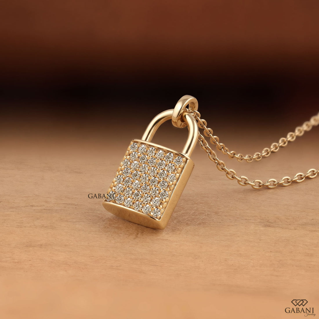 Yellow gold padlock pendant necklace featuring rows of round cut lab grown diamonds in a pavé setting with a polished gold shackle.