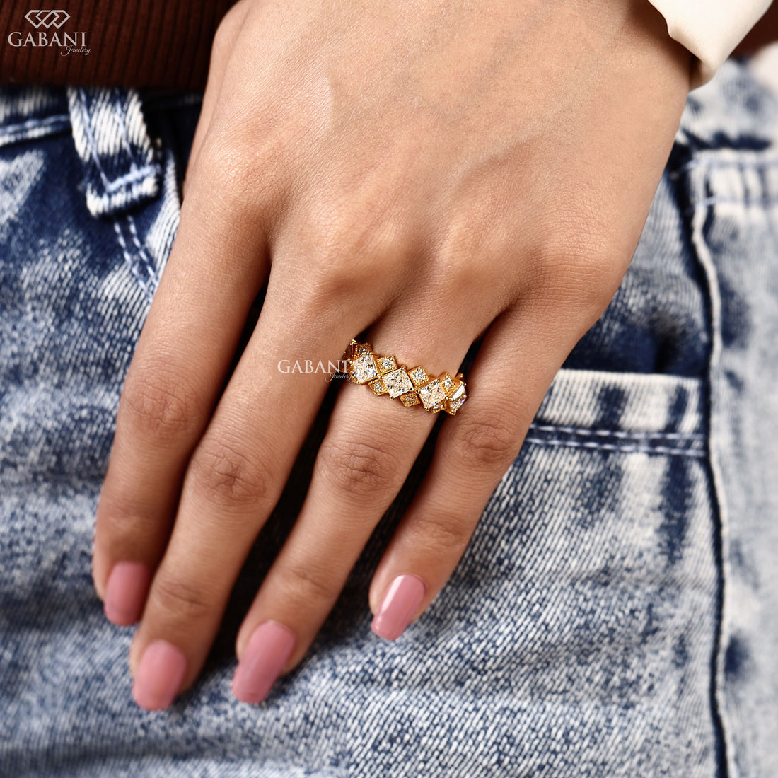 Princess cut lab grown diamond wedding band in yellow gold with round diamond accents and a geometric half eternity design for bridal and anniversary wear.