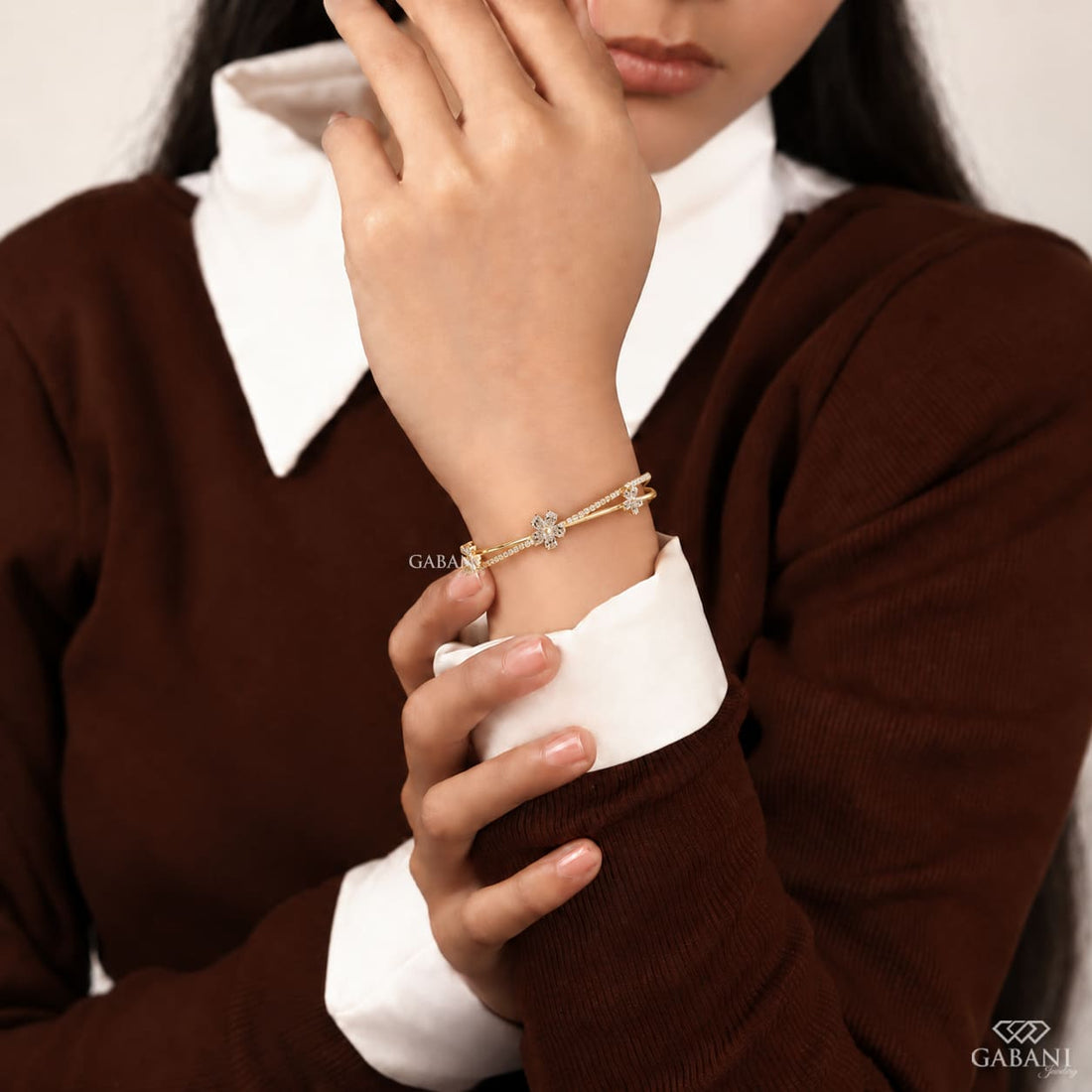 Yellow gold open cuff bangle bracelet featuring three pear cut diamond flower clusters and round pavé diamond accents.