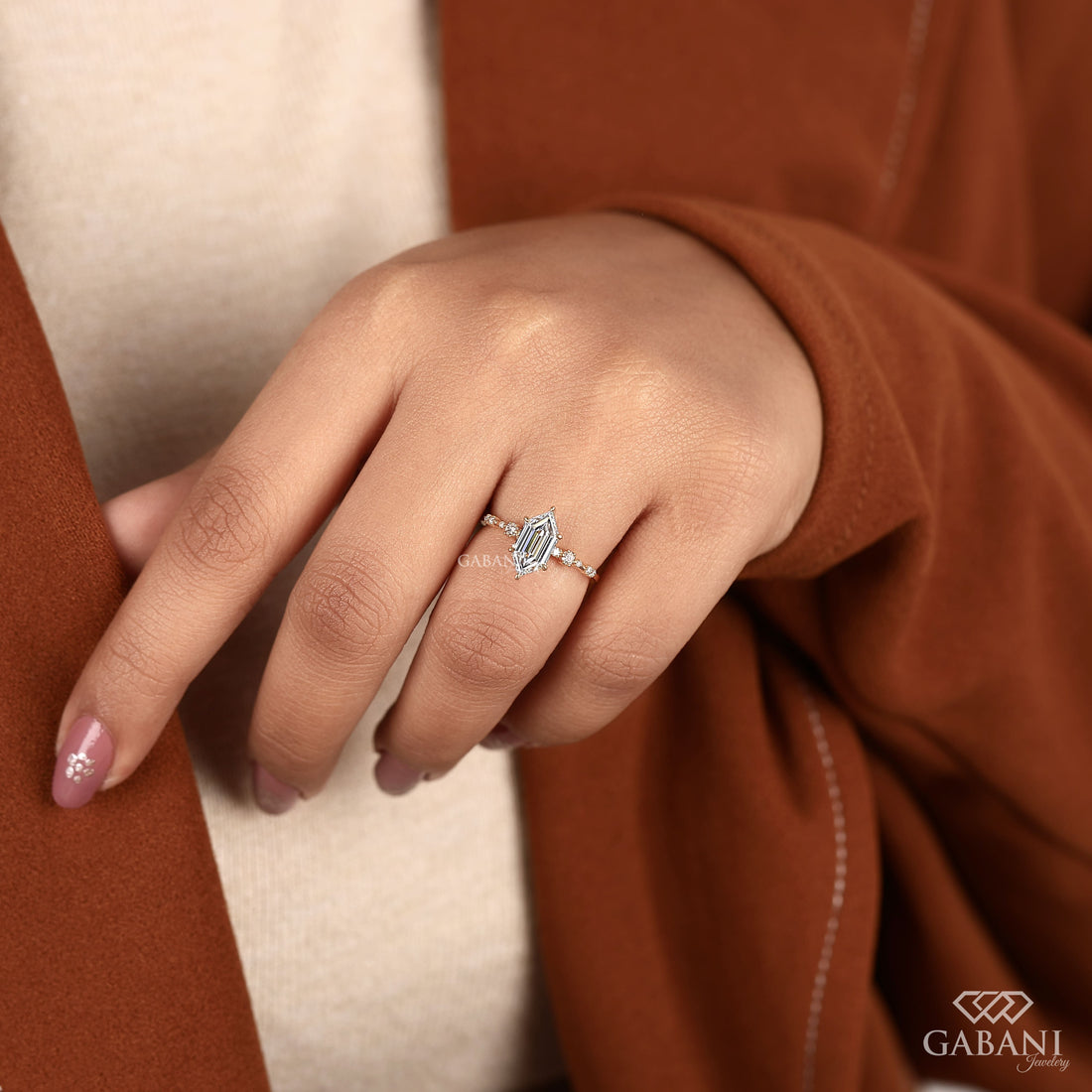 Dutch marquise lab grown diamond engagement ring with elongated geometric center stone, round side diamond accents and gold band.