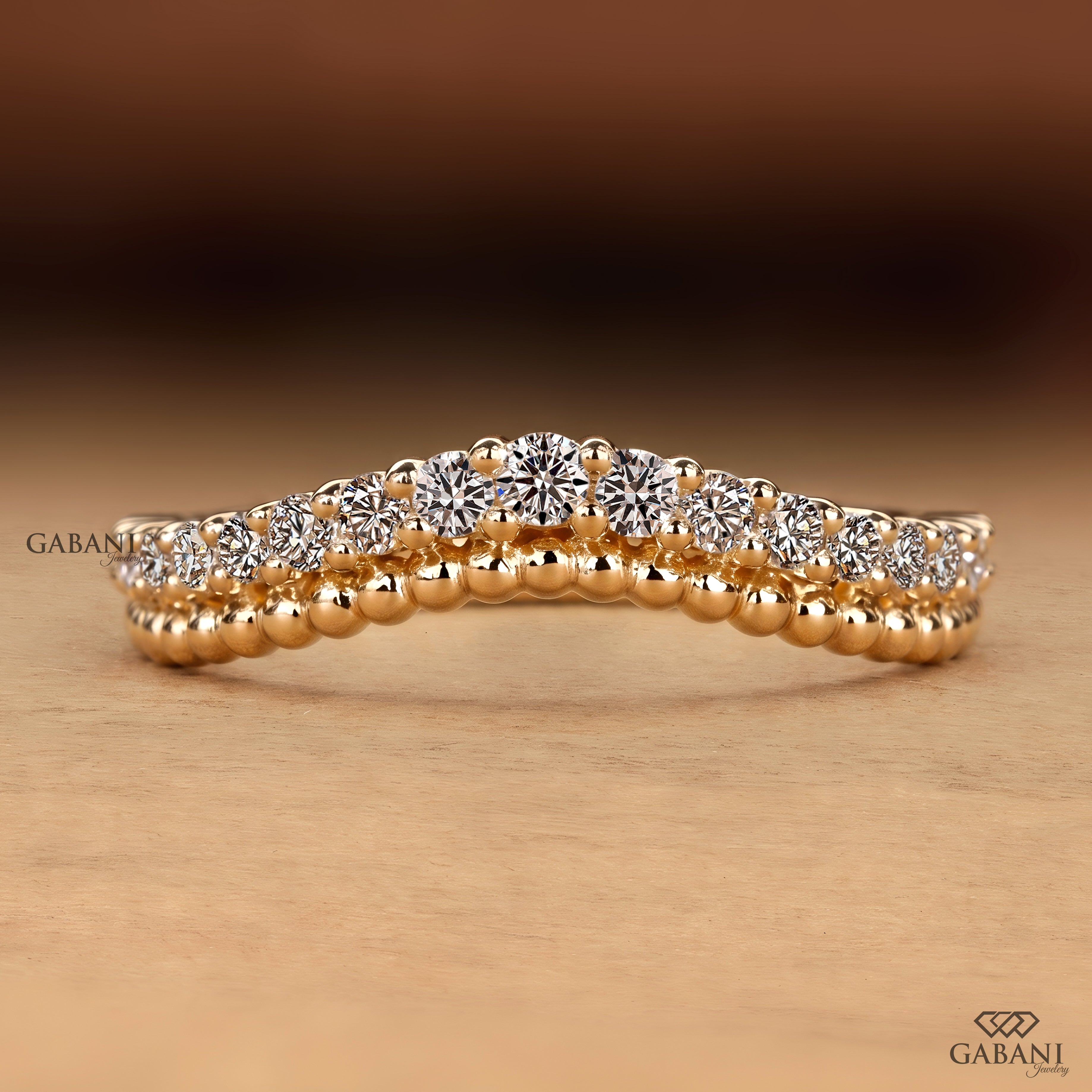 A close-up of a rose gold ring with a double row of round brilliant-cut diamonds, set against a warm brown and beige gradient background. The Gabani brand logo is visible in the bottom right corner.