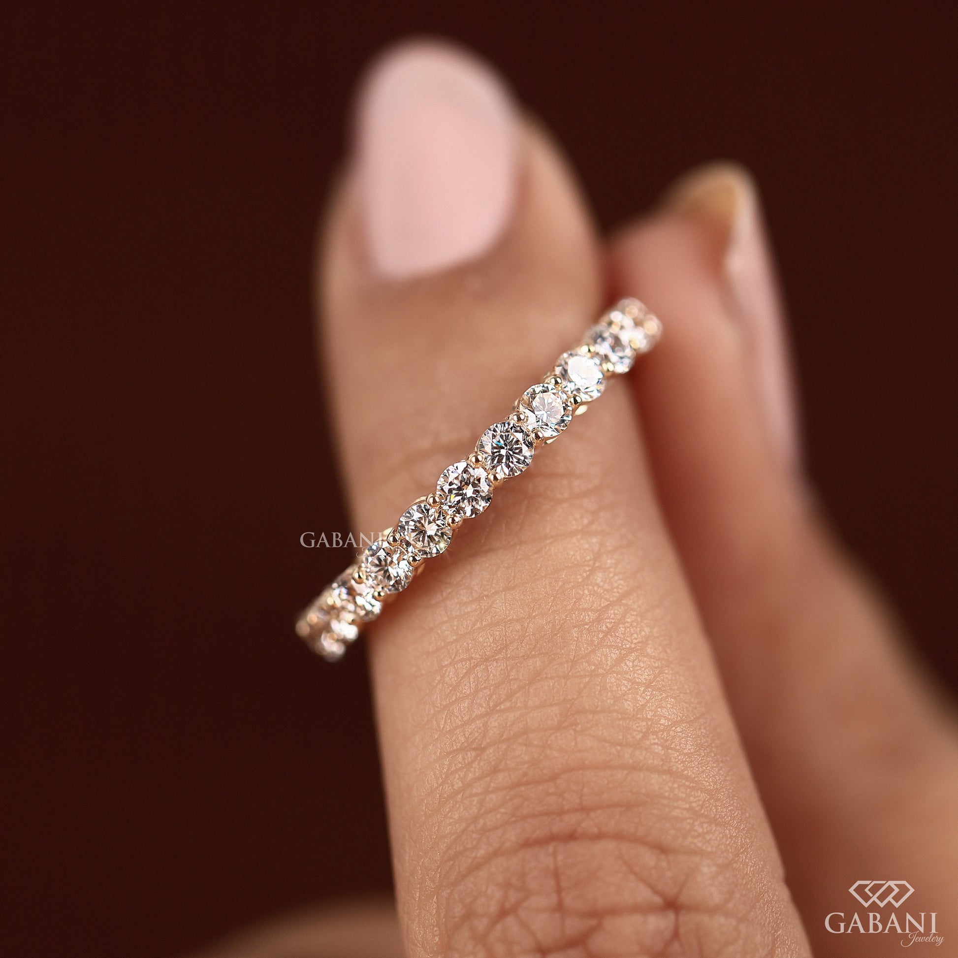 Round lab grown diamond band in rose gold with prong set half eternity design