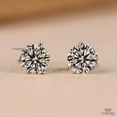 Round natural diamond solitaire stud earrings in white gold with three button prong setting