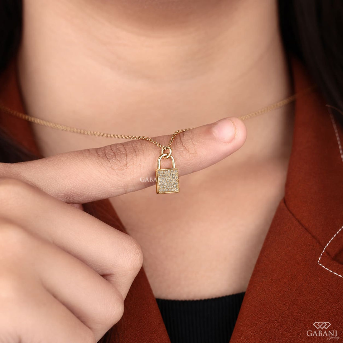 Yellow gold padlock pendant necklace featuring rows of round cut lab grown diamonds in a pavé setting with a polished gold shackle.
