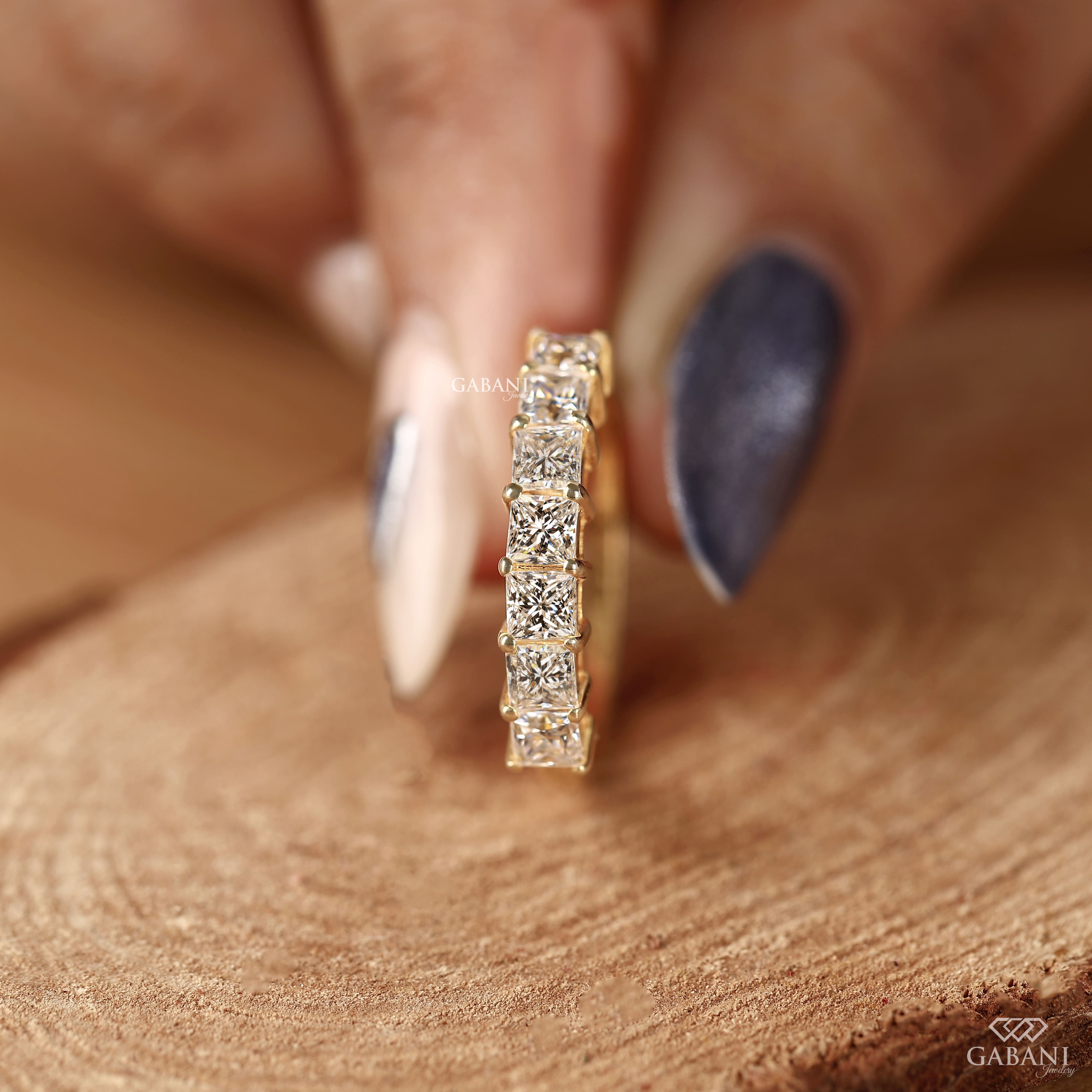 seven stone princess cut lab grown diamond wedding band in 14K yellow gold. A classic half eternity ring for weddings, anniversaries and stacking.