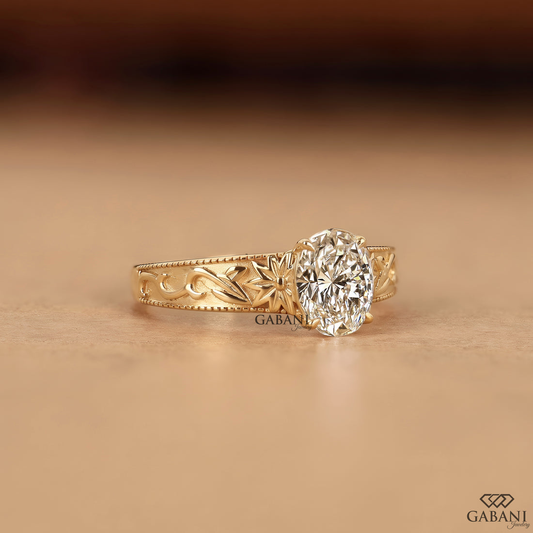 Oval cut lab grown diamond proposal ring with engraved leaf details