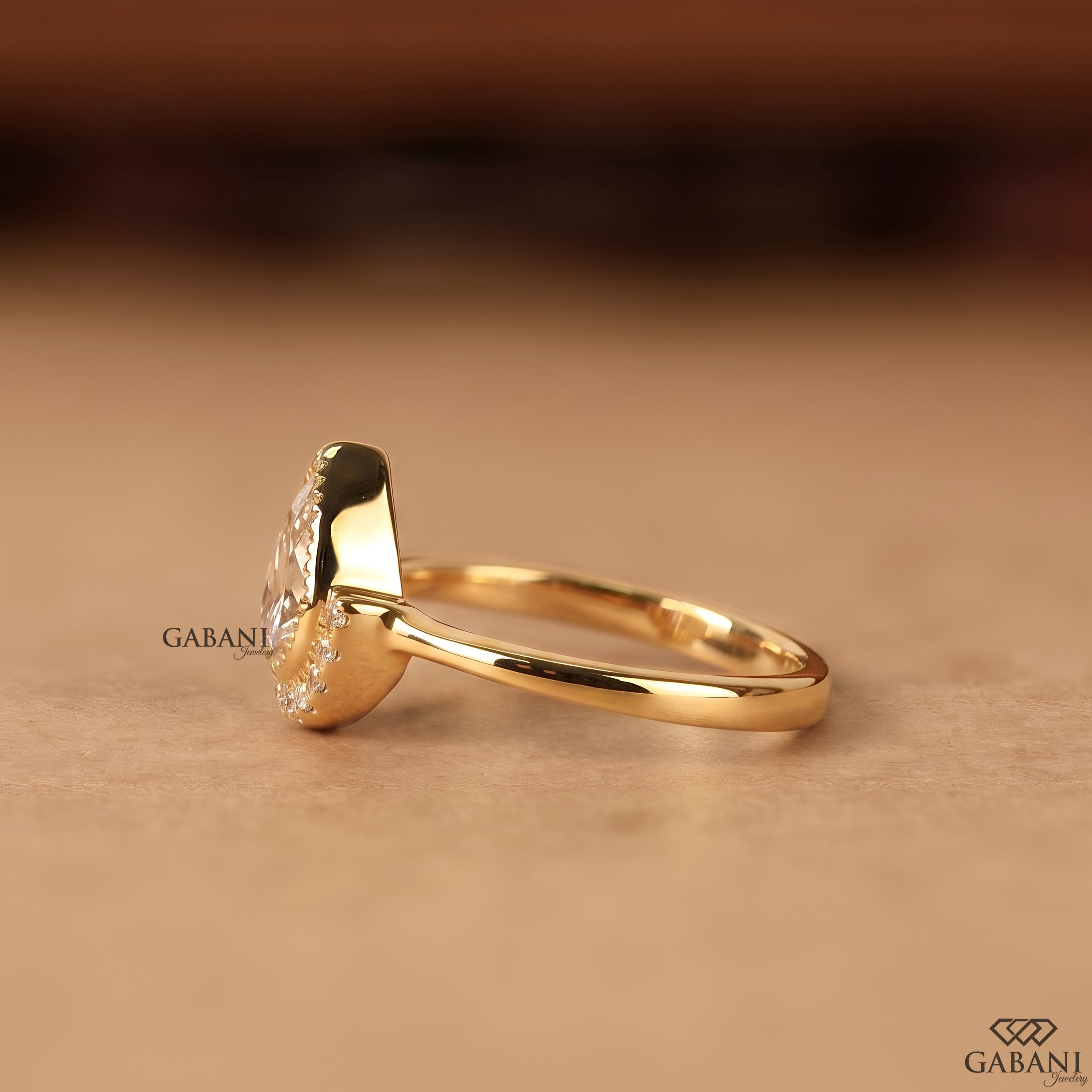 Pear cut lab created diamond engagement ring with bezel setting and halo