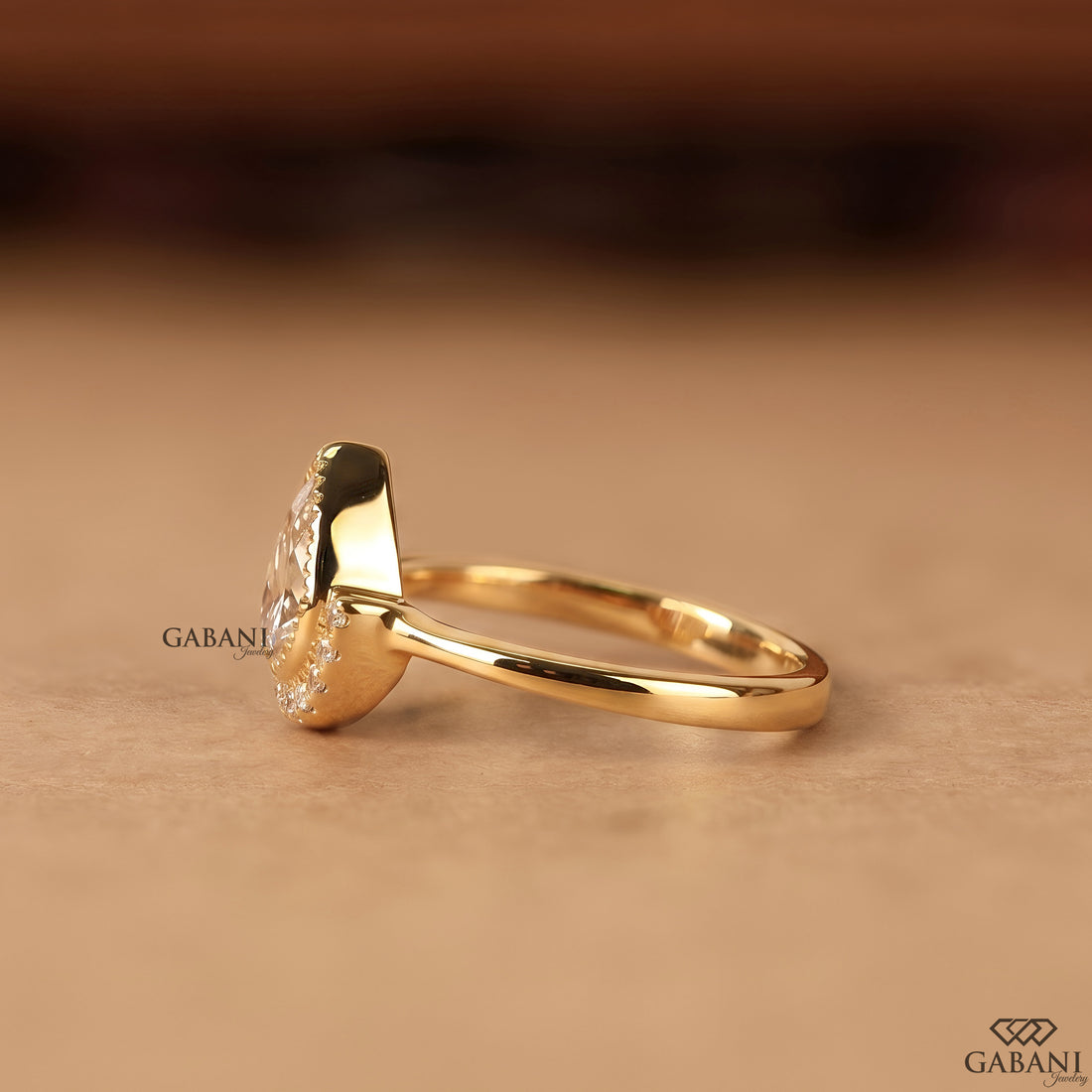 Pear cut lab created diamond engagement ring with bezel setting and halo
