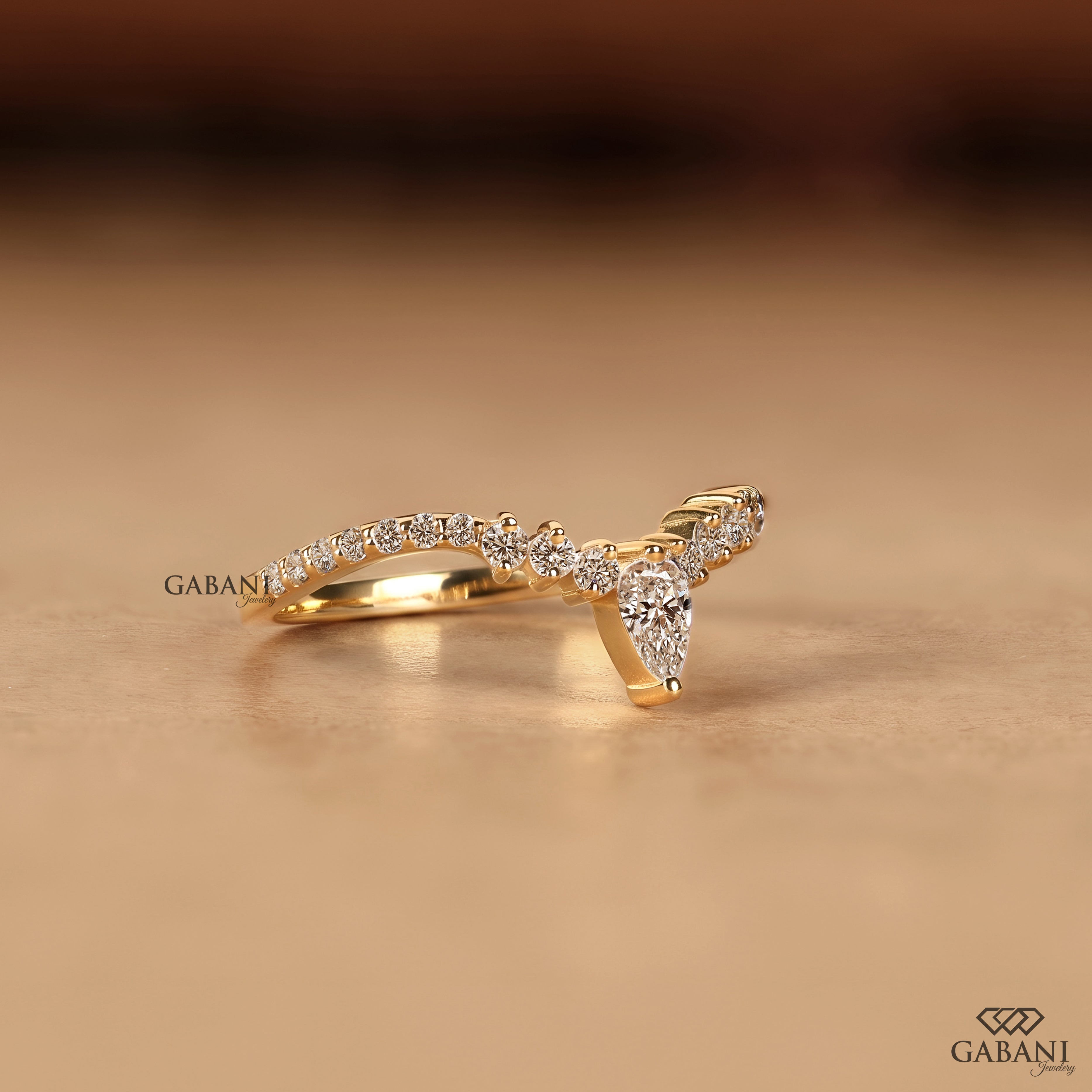 Side view of pear cut lab grown diamond V shaped chevron wedding band in solid gold
