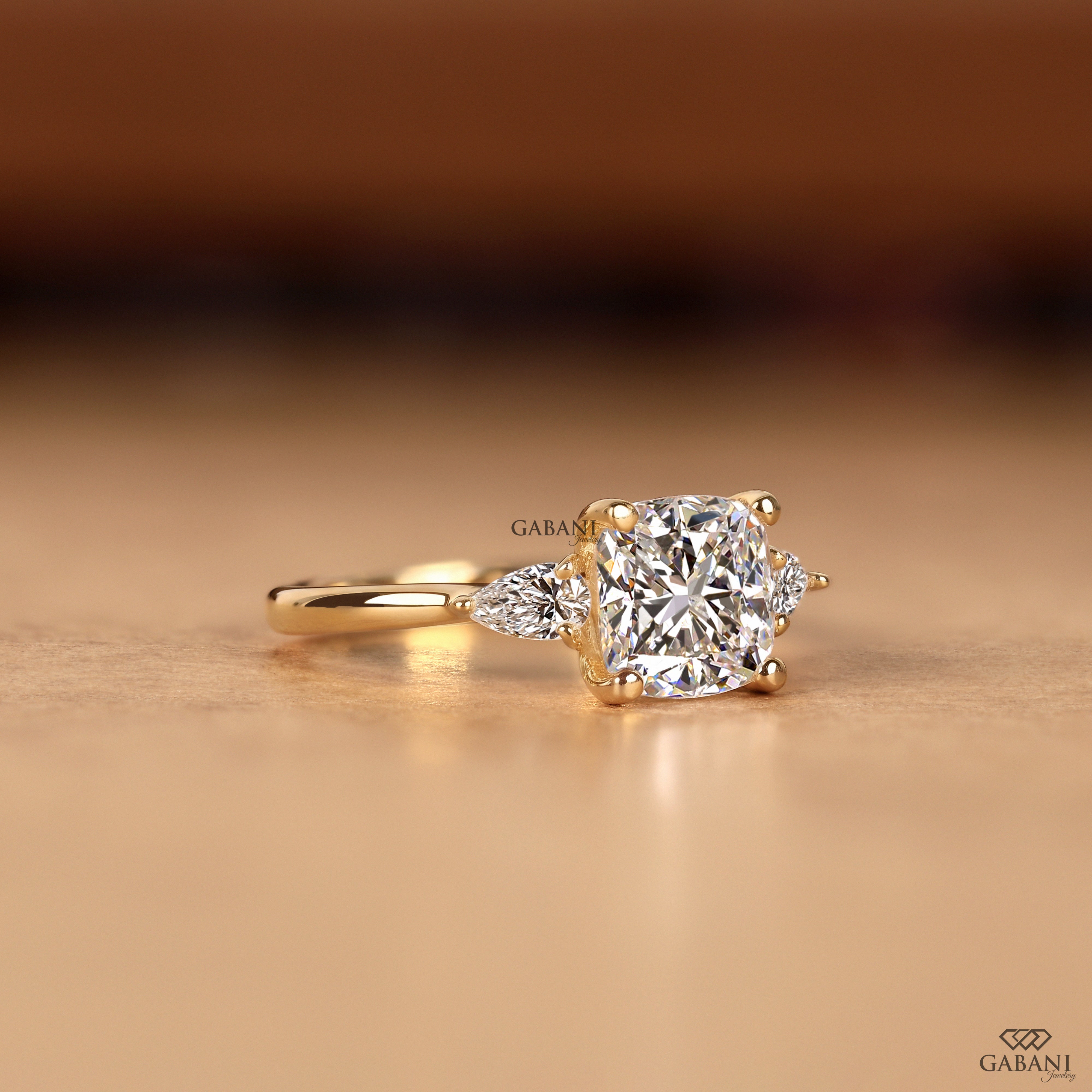 Lab grown diamond engagement ring with cushion and pear cut diamonds