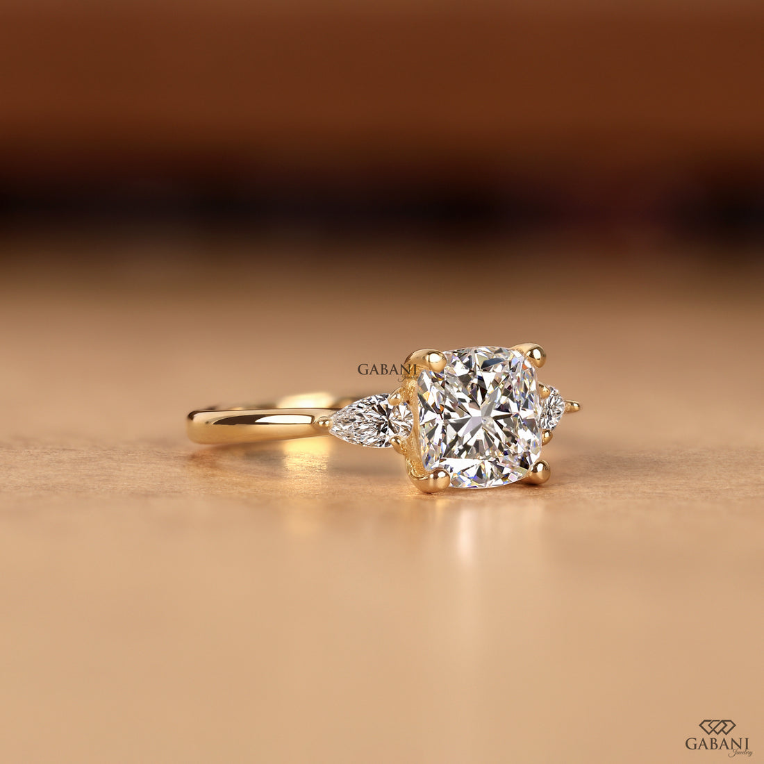 Lab grown diamond engagement ring with cushion and pear cut diamonds