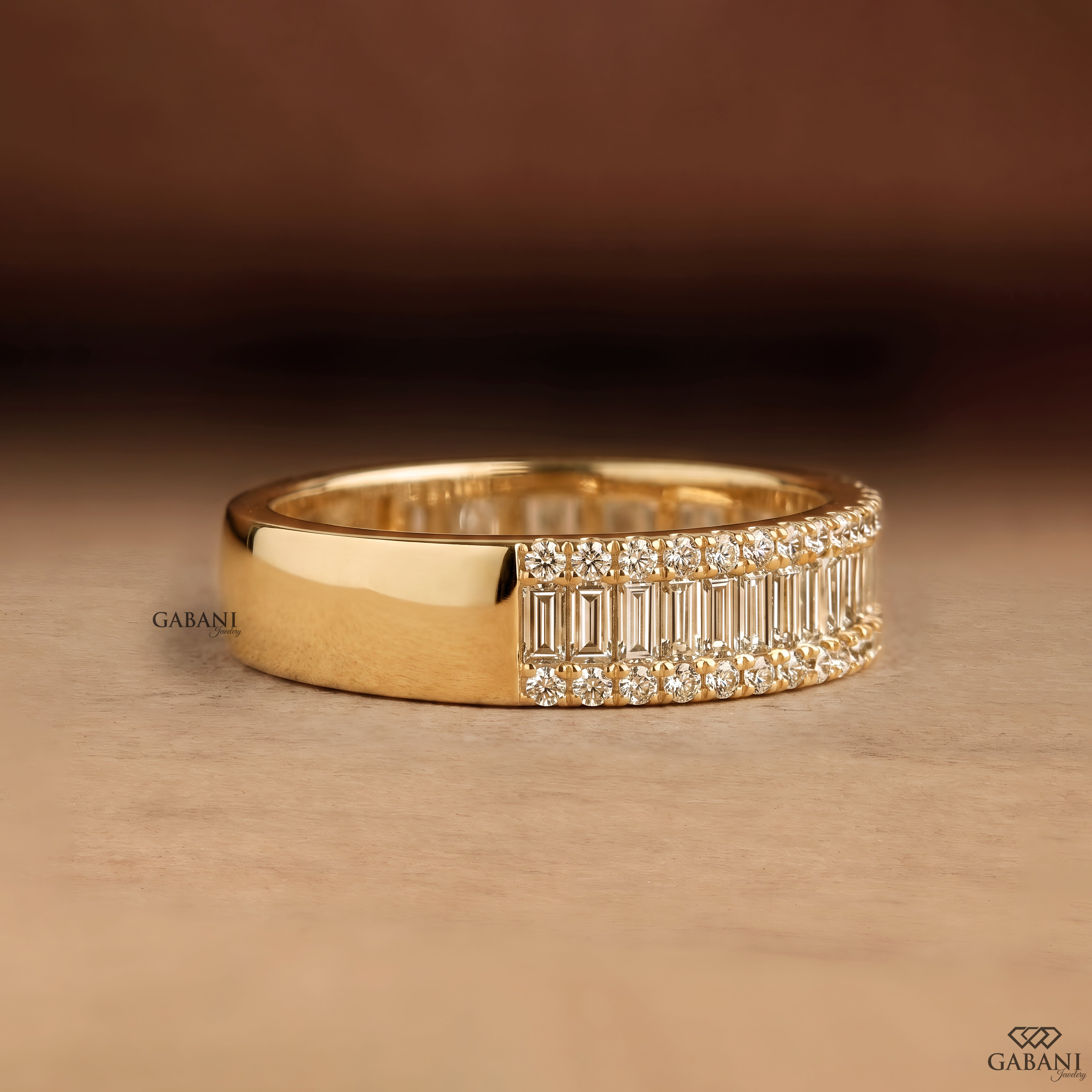 Gabani Jewelry wide yellow gold wedding band with baguette and round lab grown diamonds on model hand