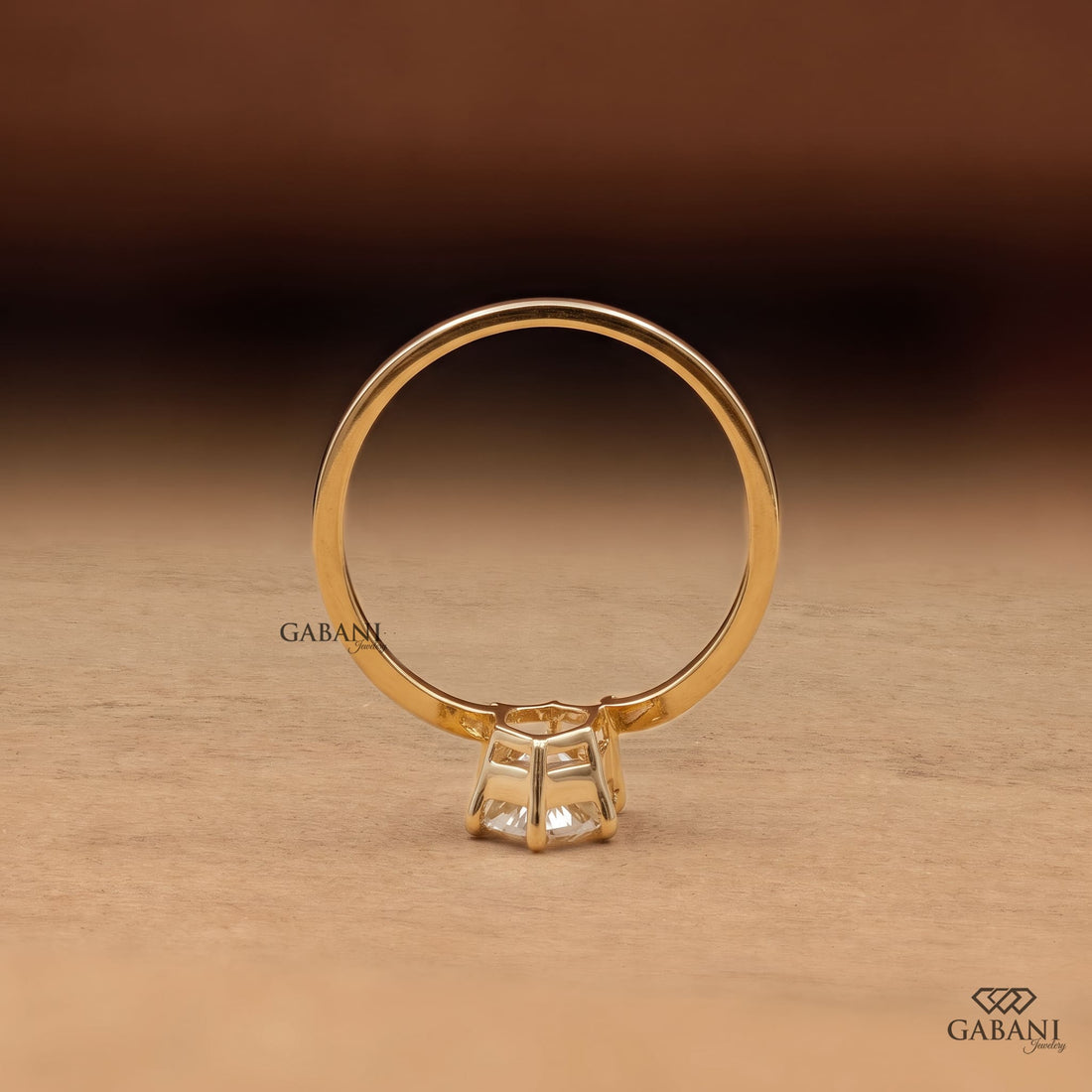 Marquise cut lab grown diamond solitaire engagement ring with six prong setting, curved shank and polished yellow gold band.