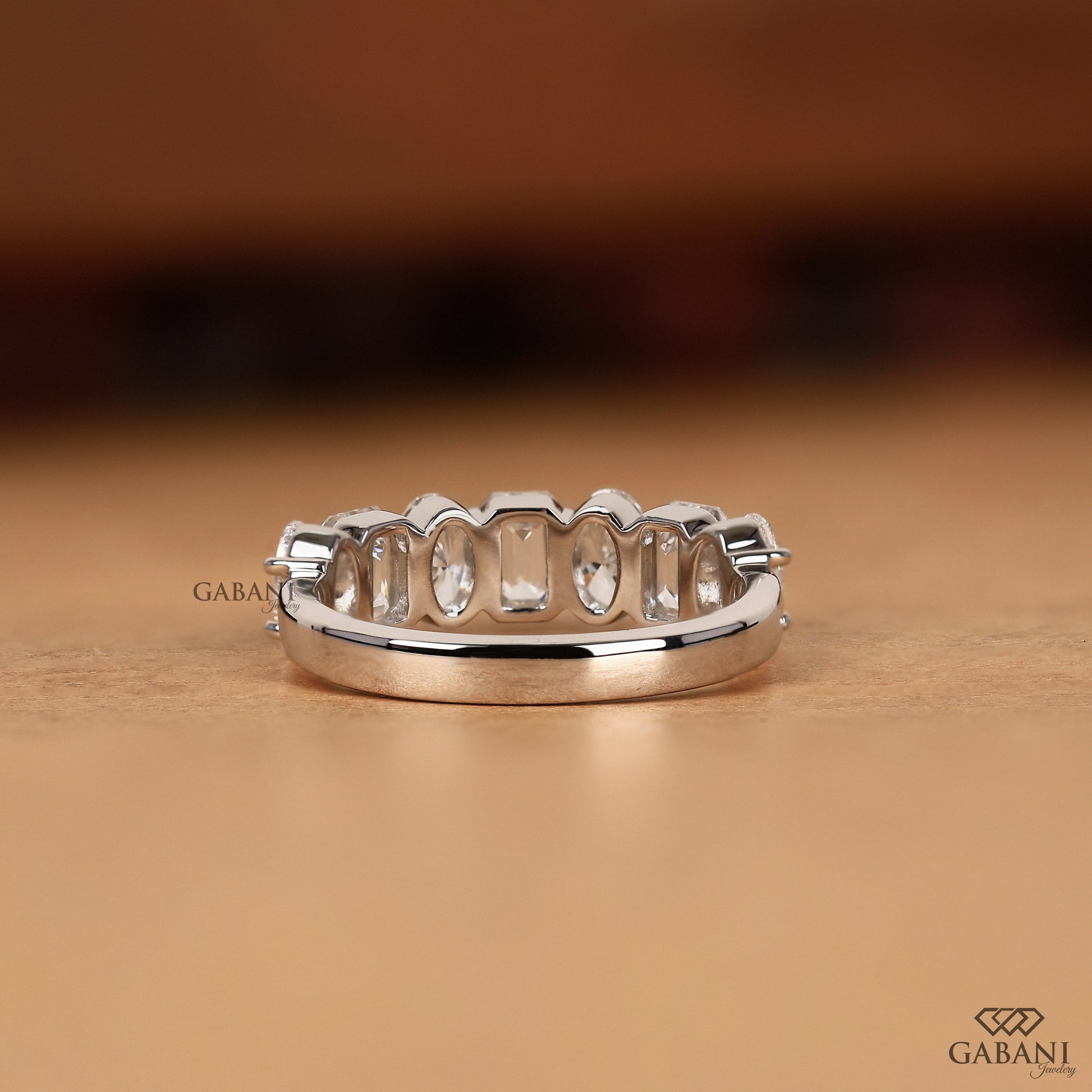 modern half eternity wedding band with oval and emerald cut lab diamonds