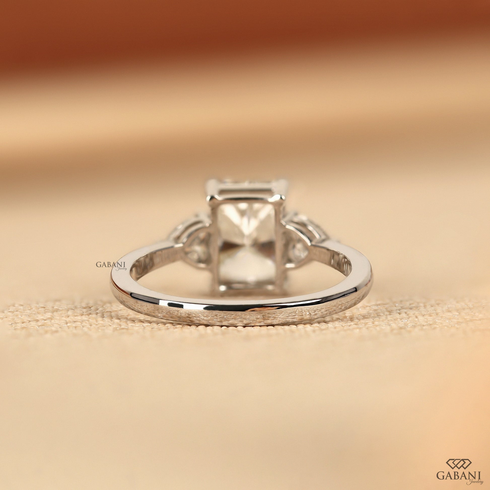 Three stone white gold ring with radiant cut lab grown diamond and heart shaped diamonds