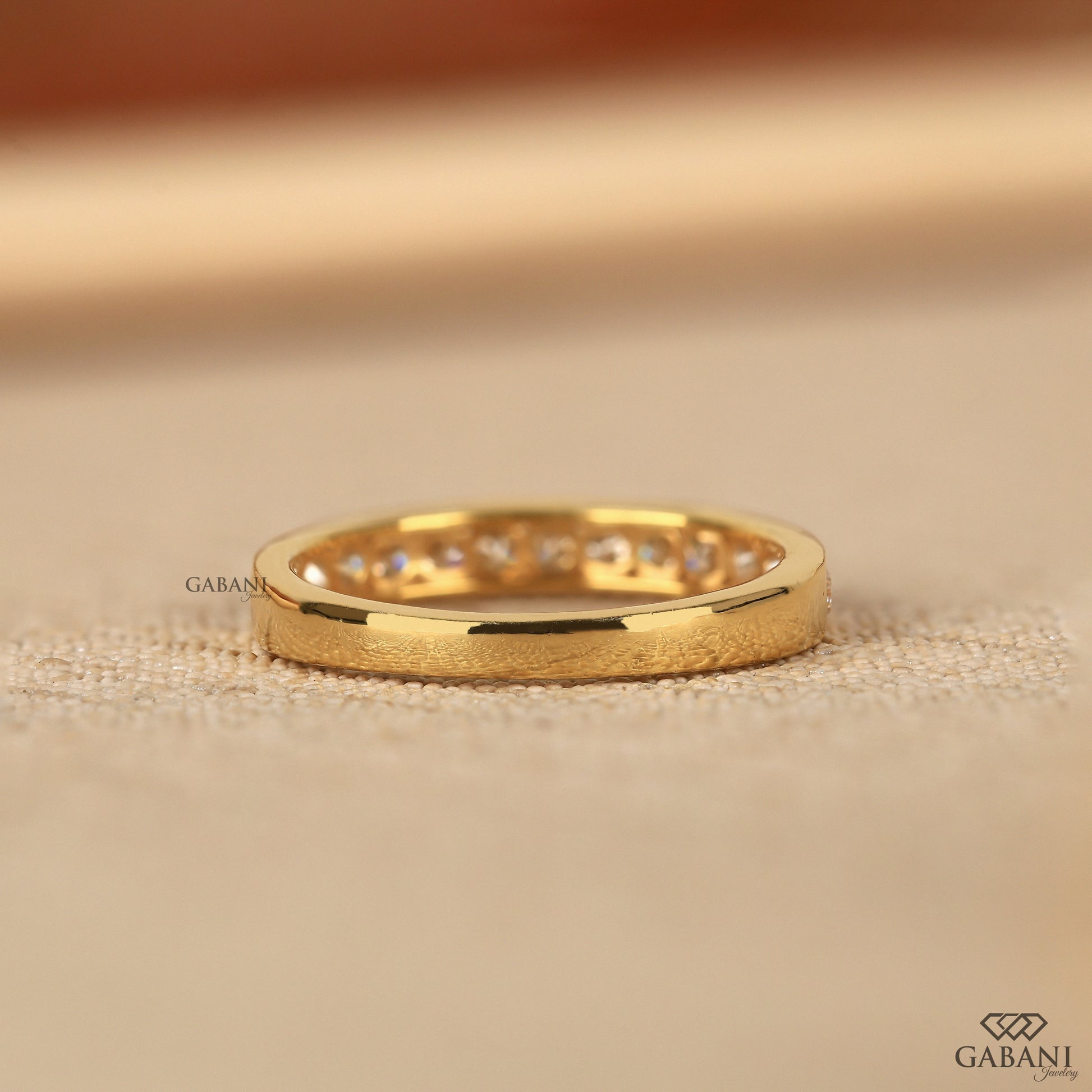 yellow gold wedding band with round lab grown diamonds in channel setting